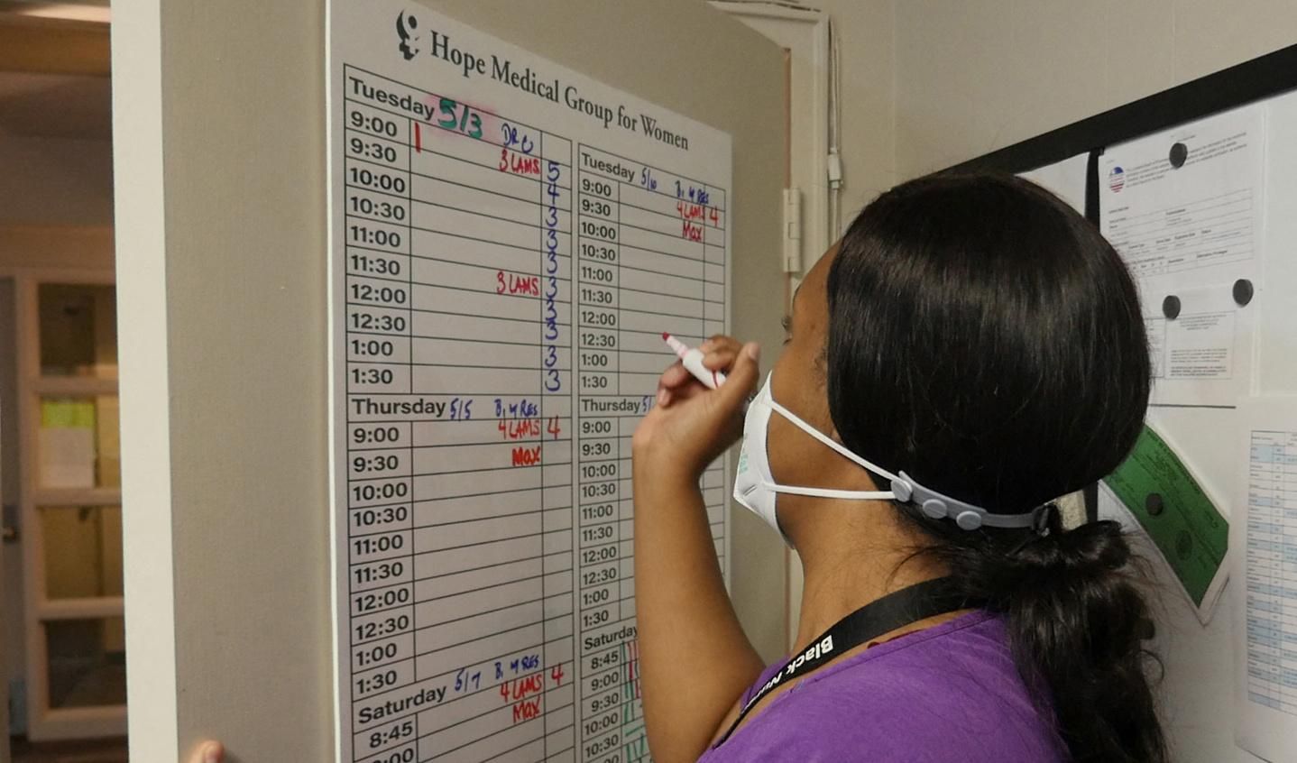 An employee at Hope Medical Group logs codes