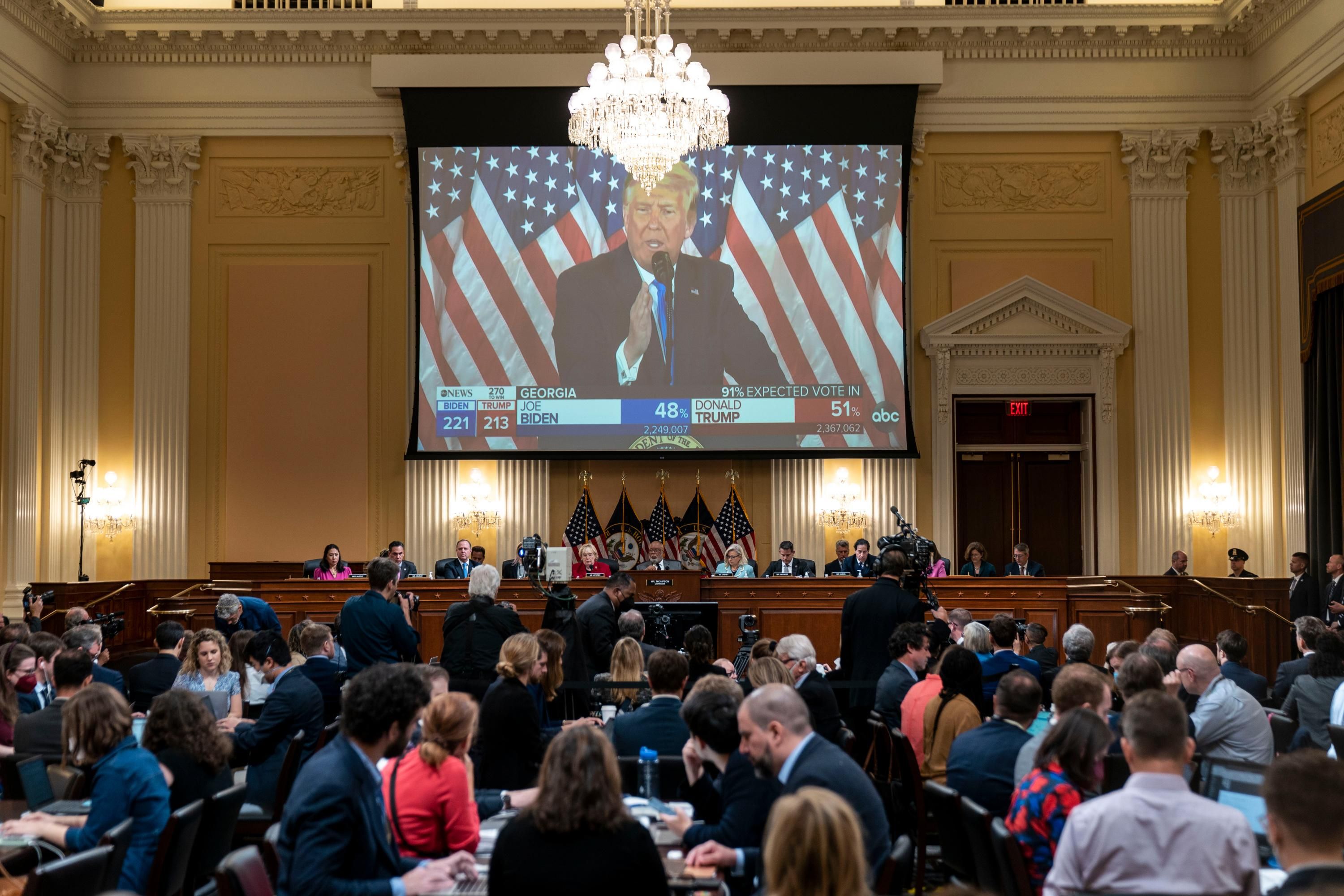 A clip of Donald Trump speaking is shown during a House hearing