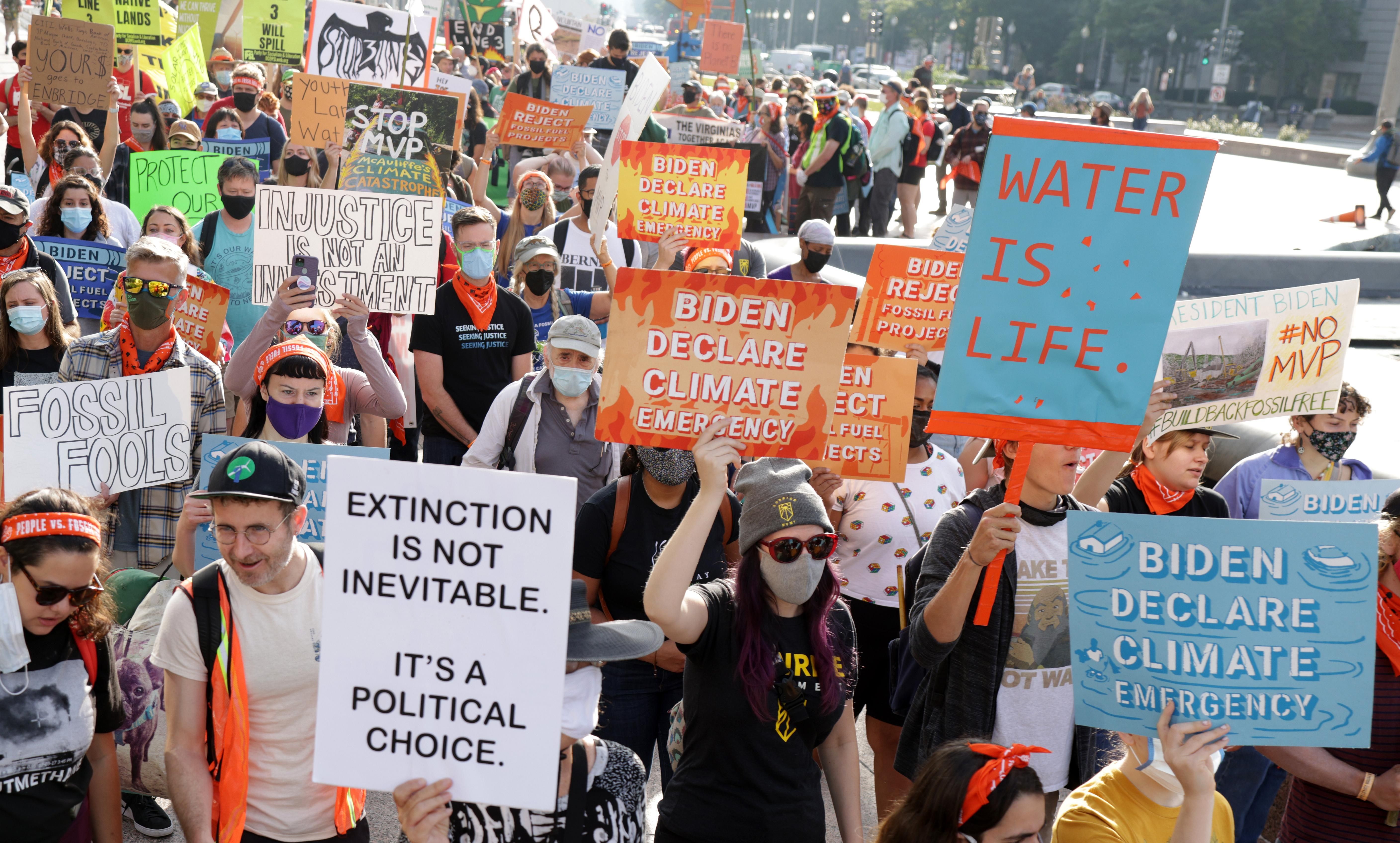 Climate activists participate in a march from Freedom Plaza to Capitol Hill on October 15, 2021 in Washington, D.C. 