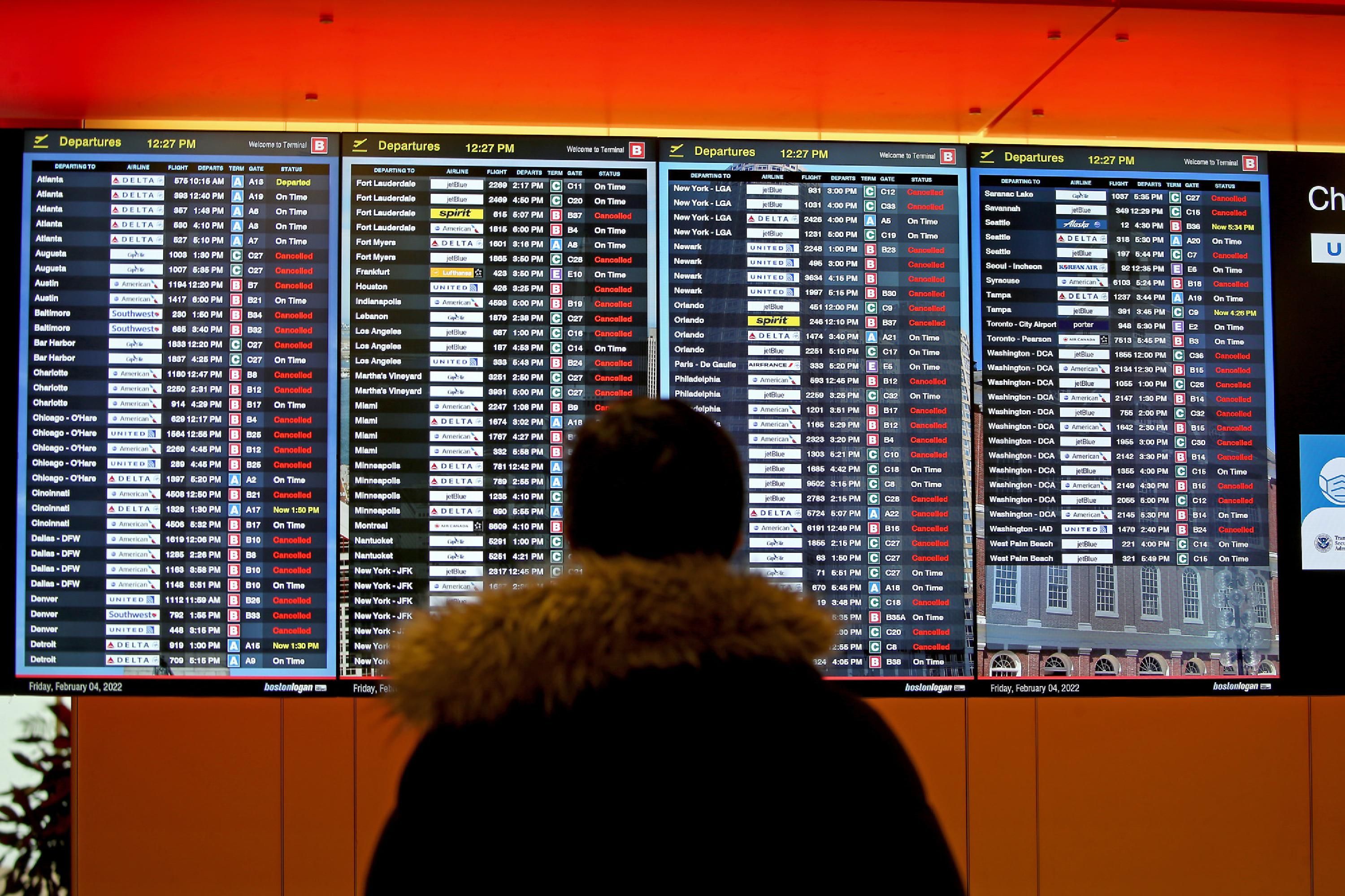 A screen shows canceled flights at Boston's airport