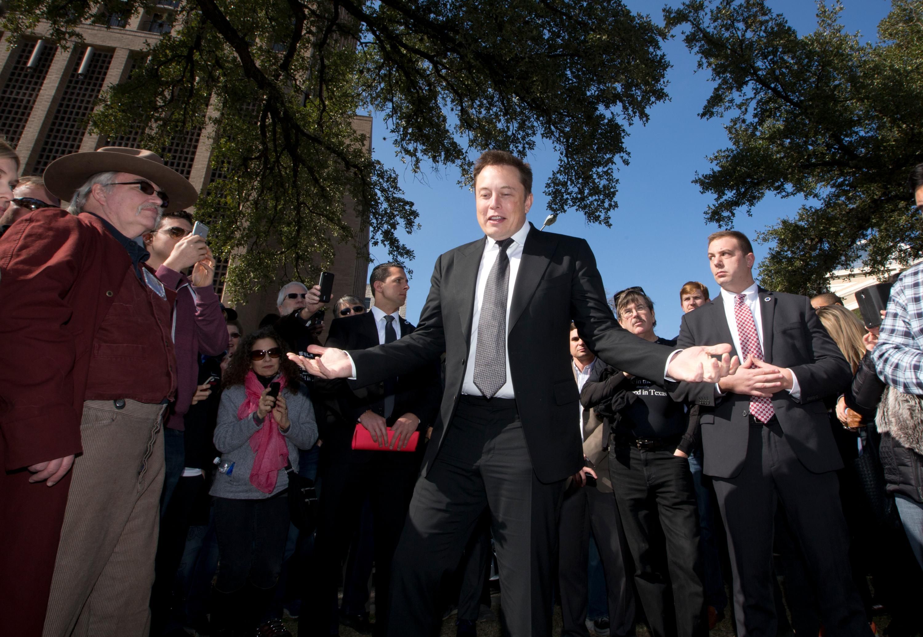CEO of Tesla Motors and SpaceX, Elon Musk speaks to a crowd of people who had gathered to participate in Tesla Motors test drives outside the Texas Capitol building in Austin