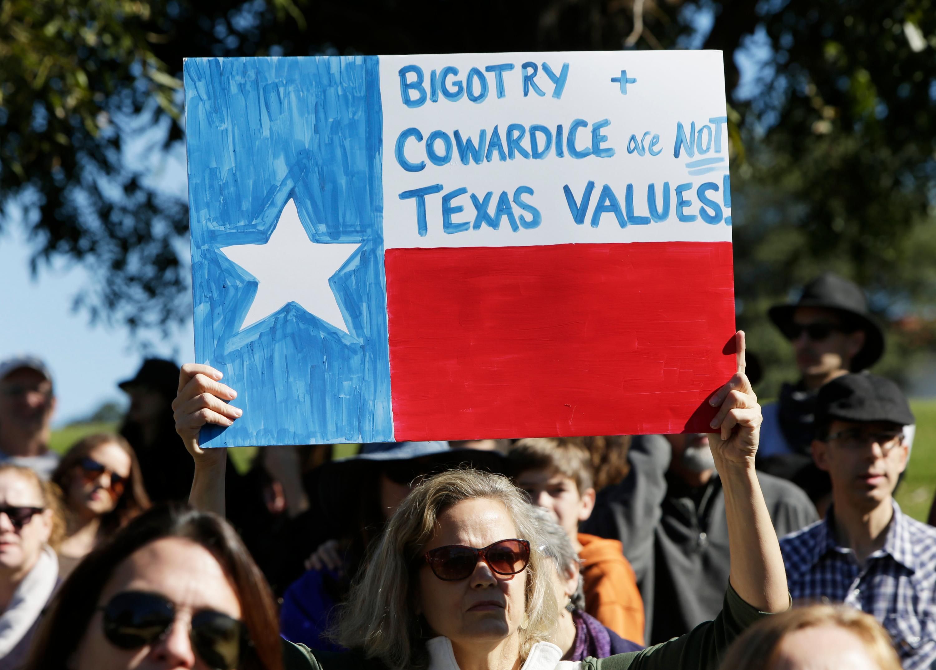 Protest sign reading, "Bigotry and cowardice are not Texas values"