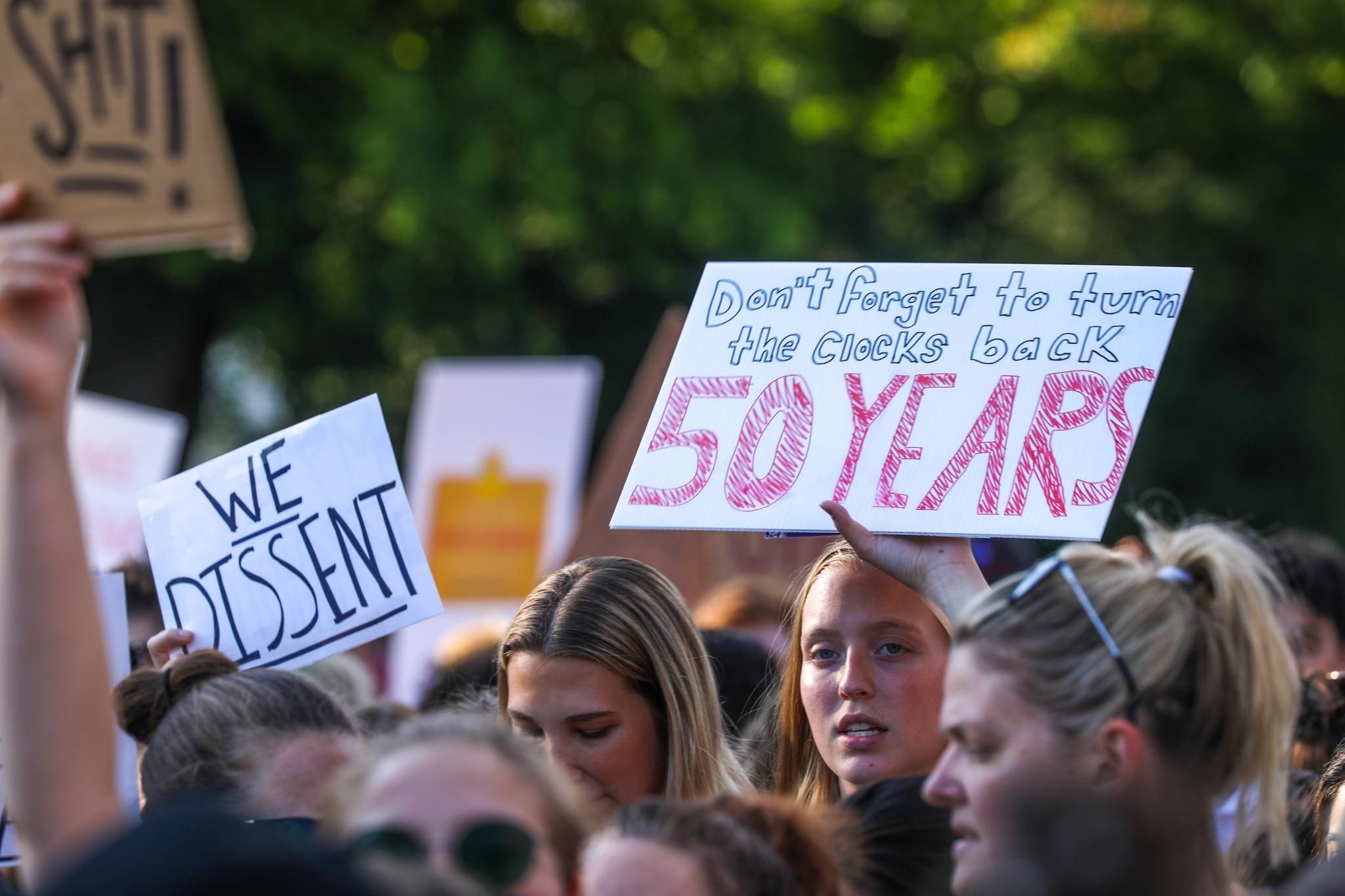 Woman holding a sign that says 