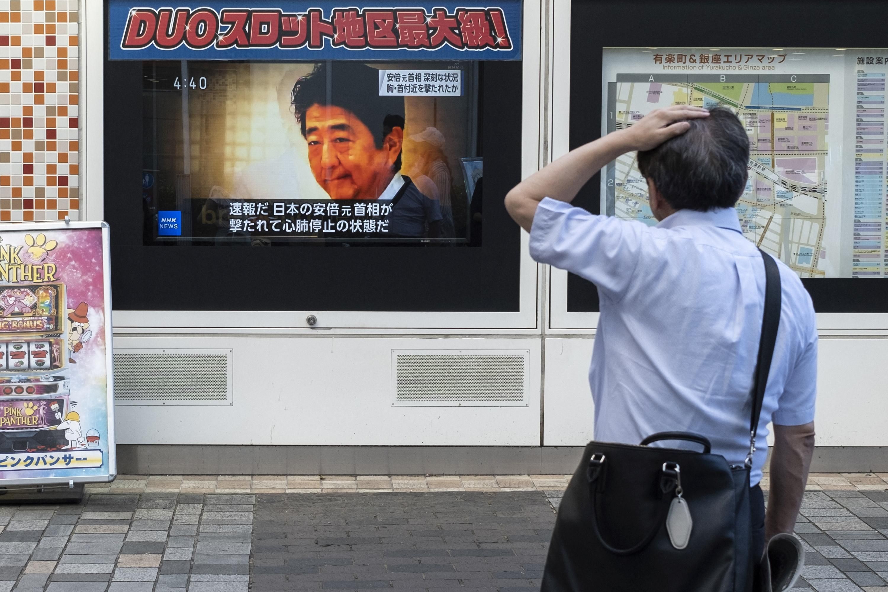 A television broadcast shows news of the attack on former Japanese Prime Minister Shinzo Abe