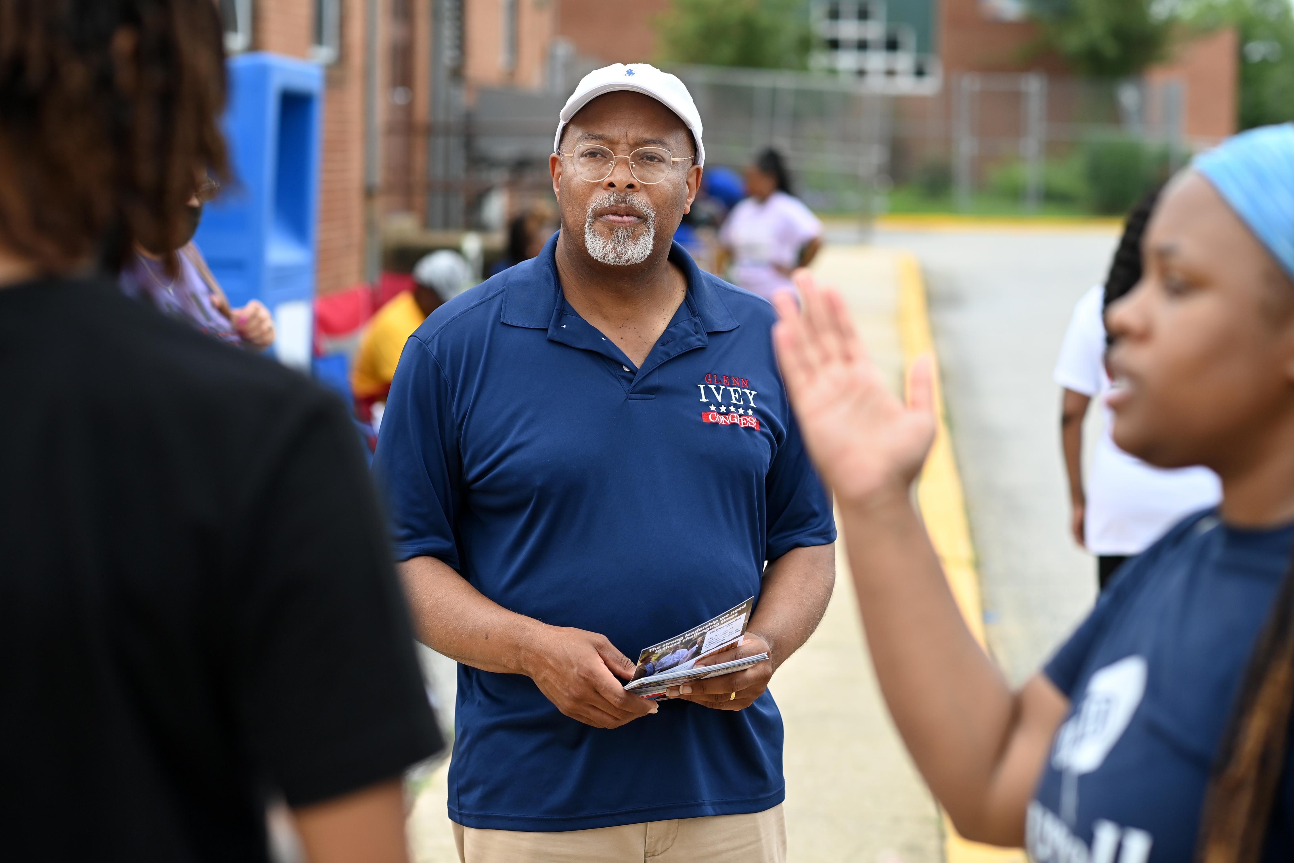 Democratic congressional candidate Glenn Ivey waits to greet a voter at Surrattsville High School on July 19, 2022 in Clinton, Maryland. 