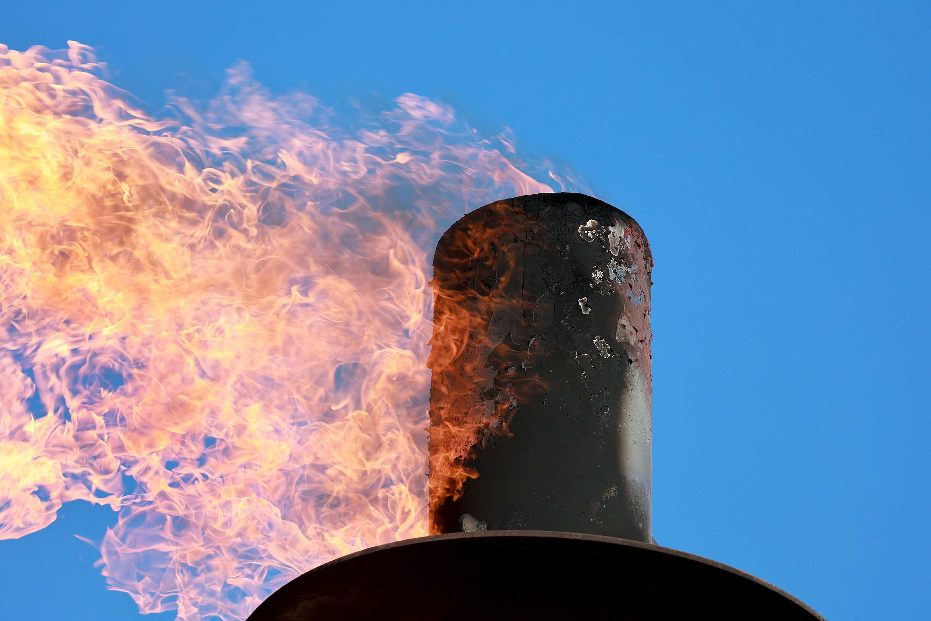 A gas flare is seen at a production site