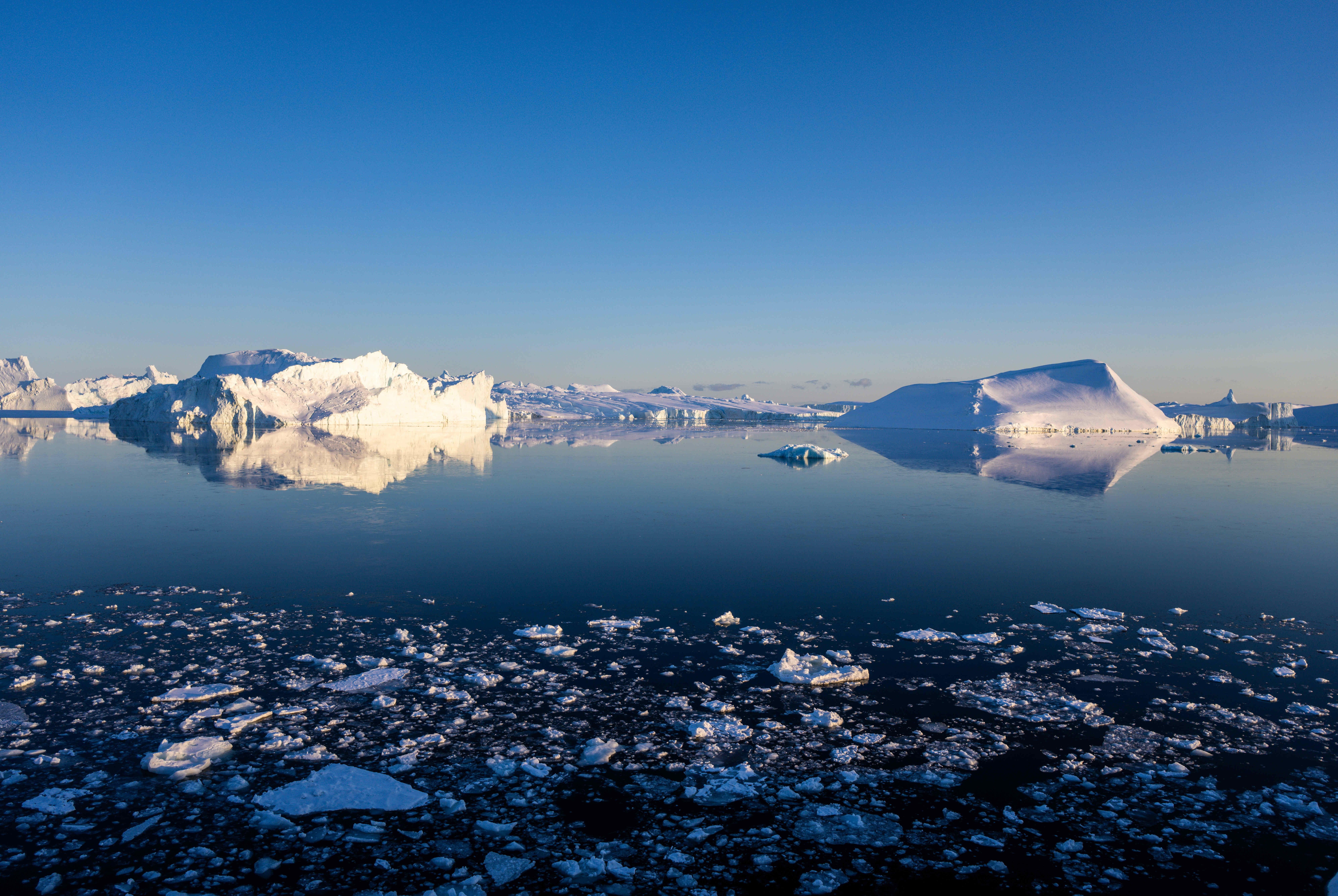 Icebergs, calved from the Sermeq Kujalleq glacier, float in the Ilulissat Icefjord off the coast of Greenland on May 16, 2022.