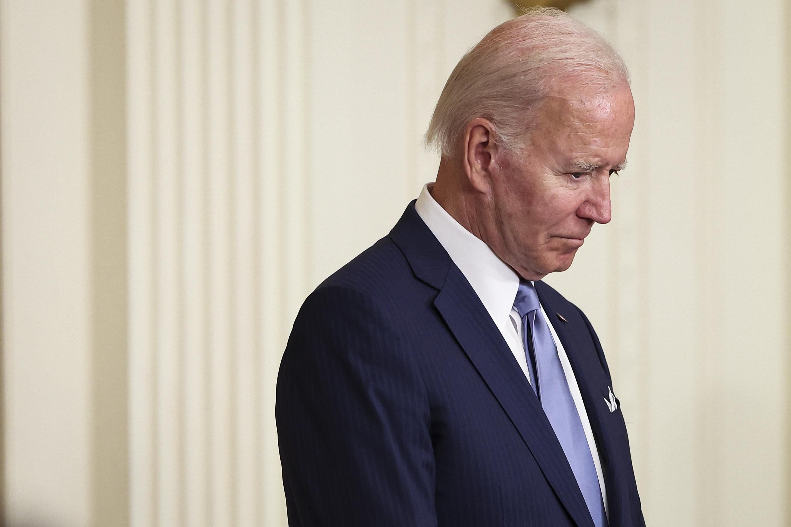 Joe Biden with his head bowed.
