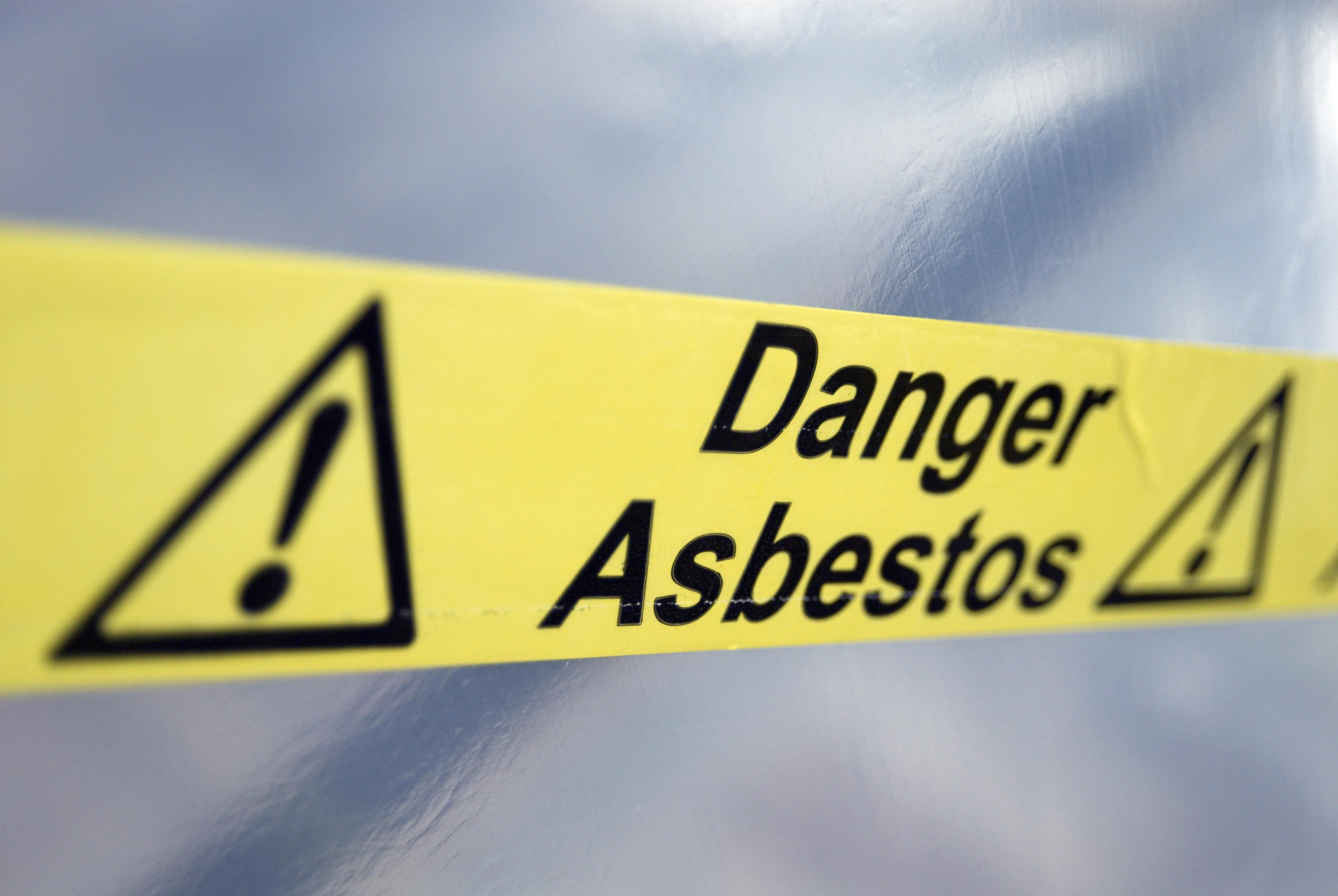 Warning tape that reads "Danger Asbestos"
