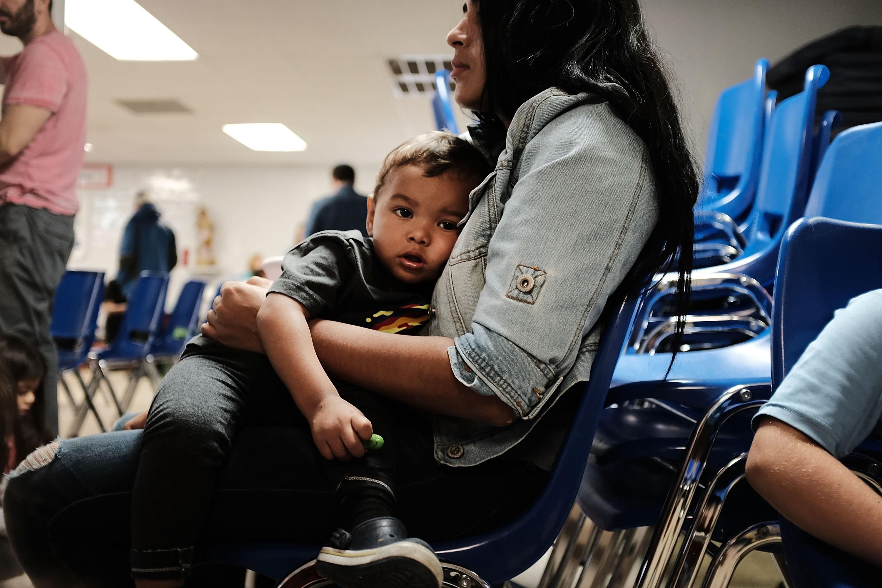 A mother sits with her child in McAllen, Texas