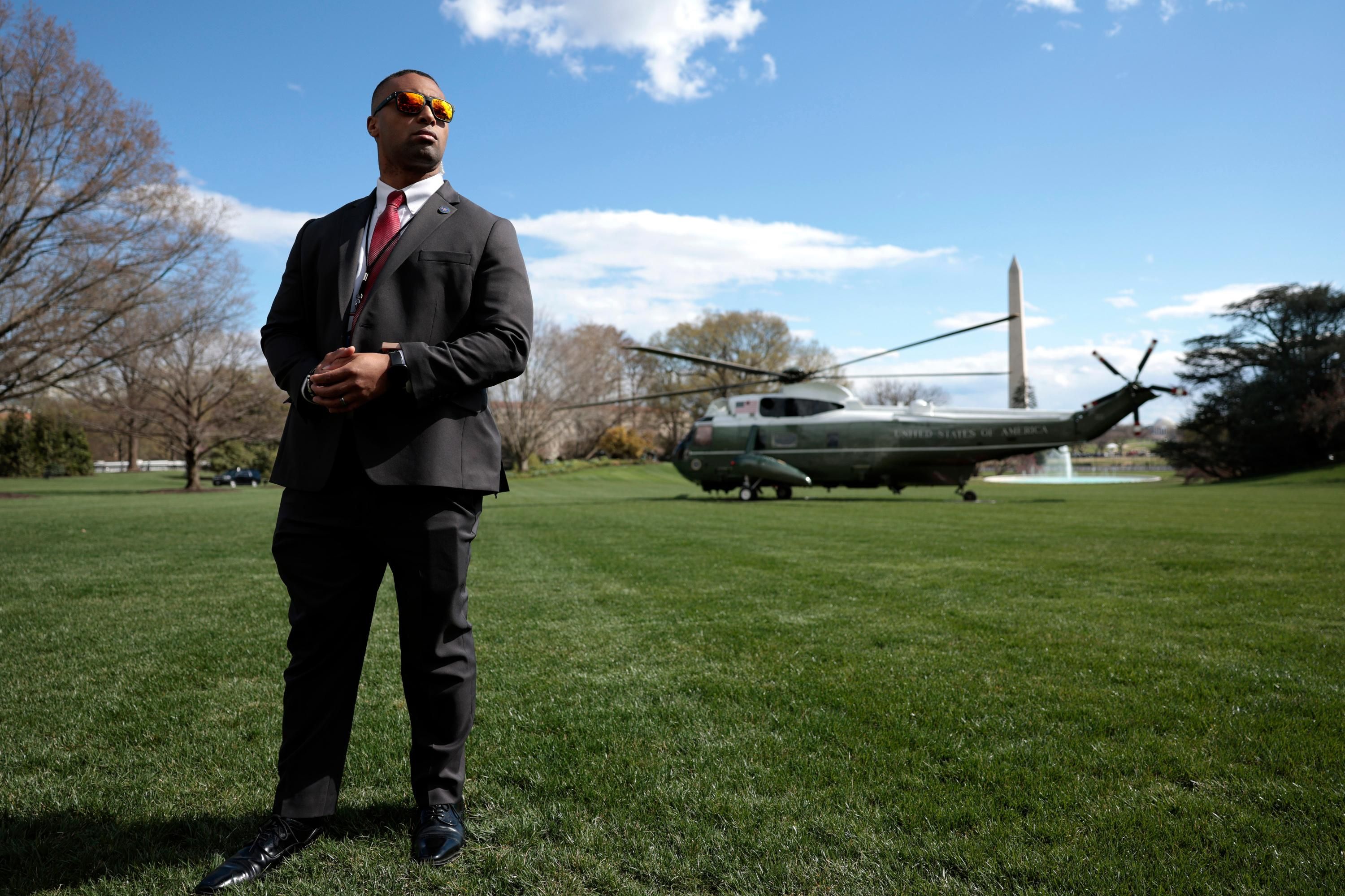 A Secret Service Agent looks on as Marine One, carrying U.S. President Joe Biden lifts off from the South Lawn of the White House on April 01, 2022 in Washington, DC. President Biden is spending the weekend at his home in Wilmington, Delaware. (Photo by Anna Moneymaker/Getty Images)