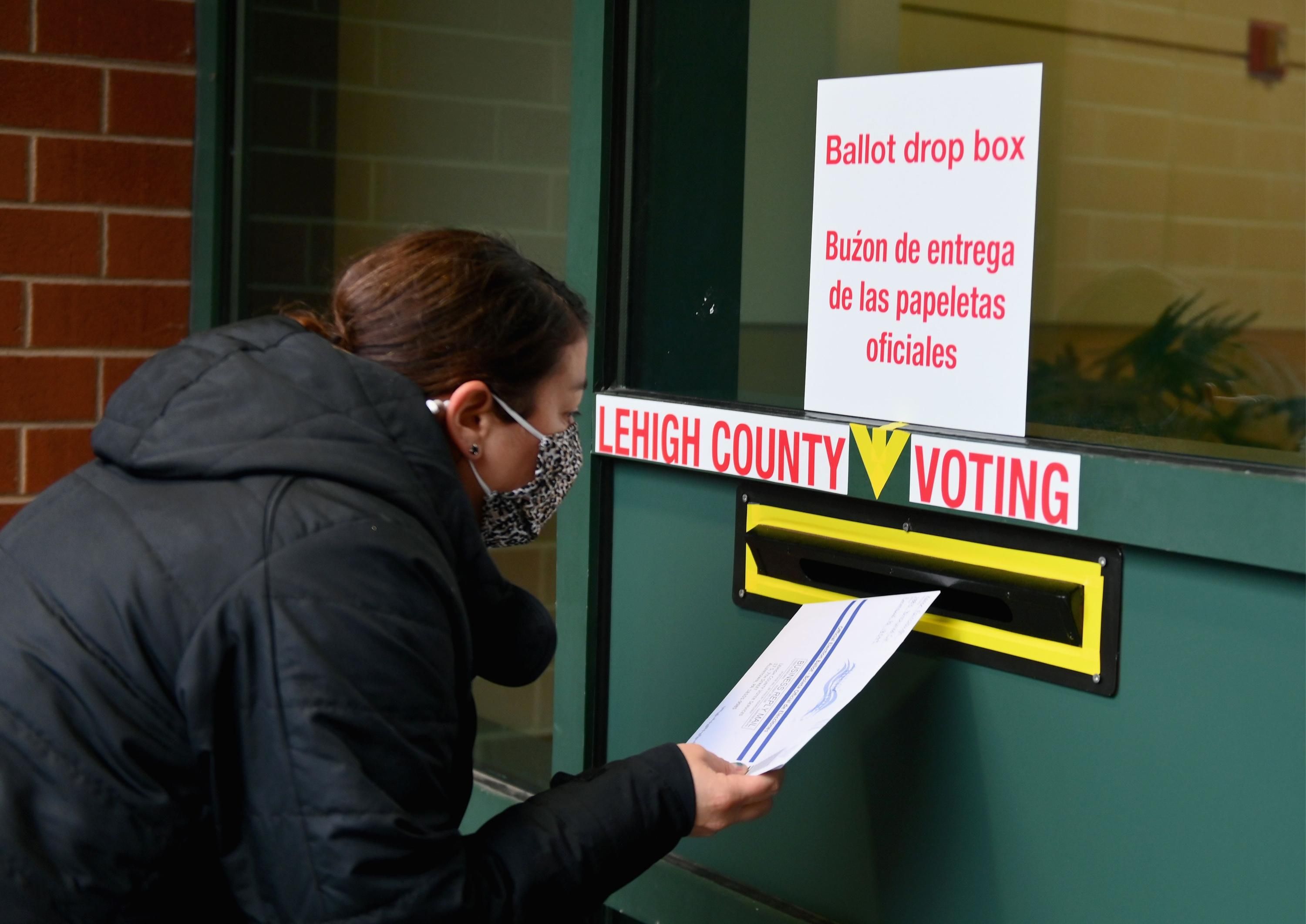 A voter drops off a ballot in Pennsylvania