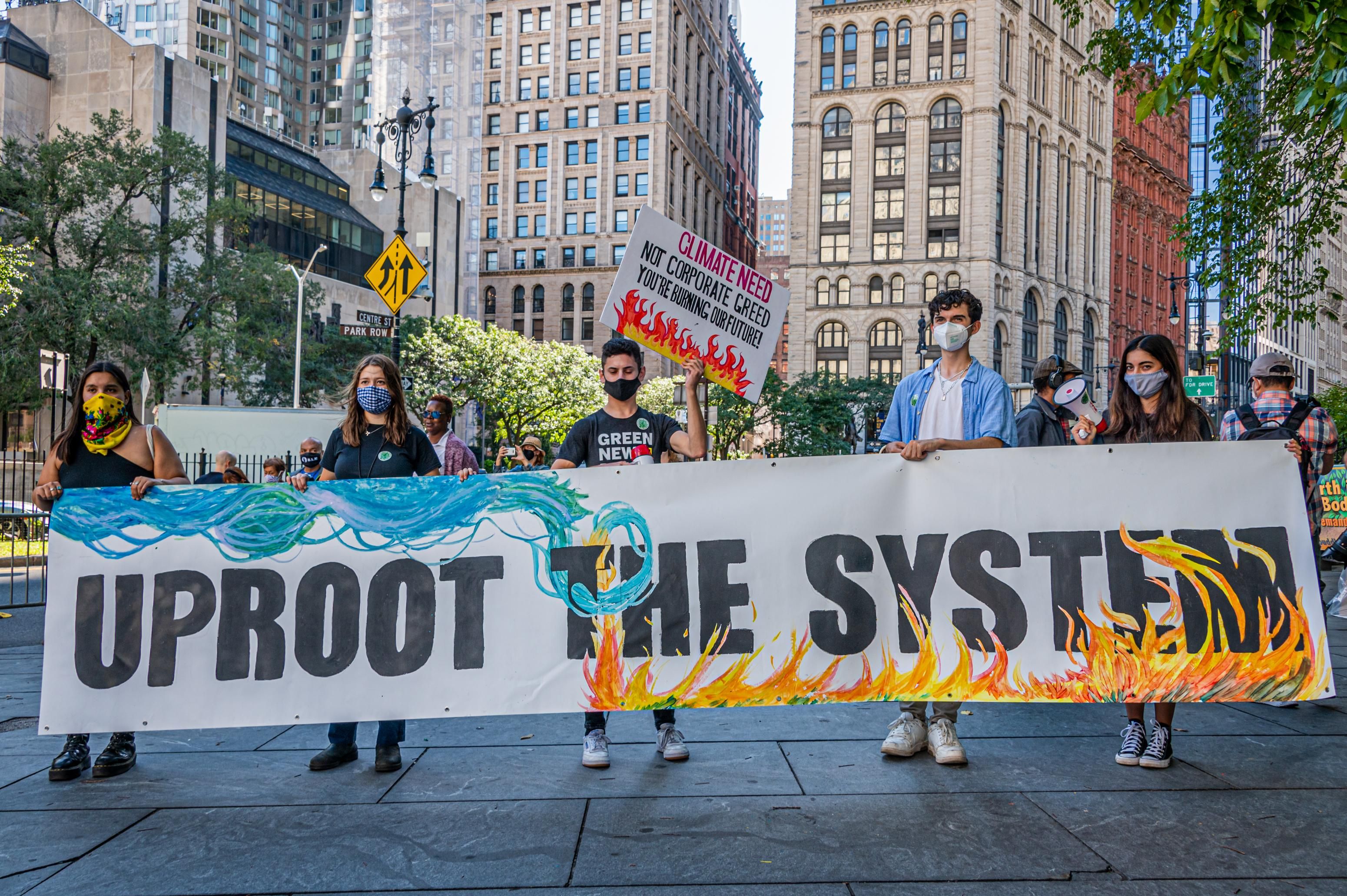 Climate activists holding sign that reads 