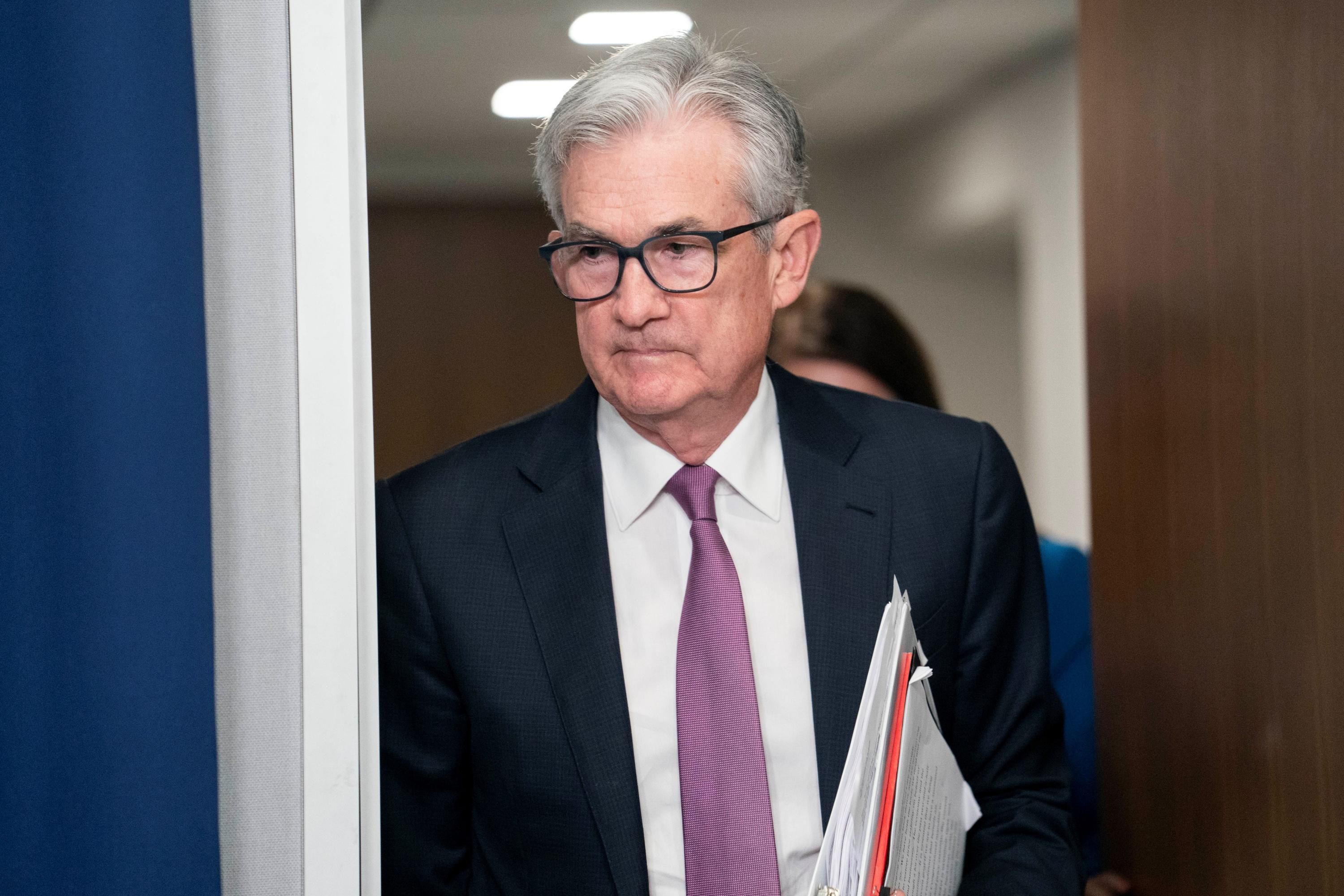 Fed chair Jerome Powell walks to a press conference