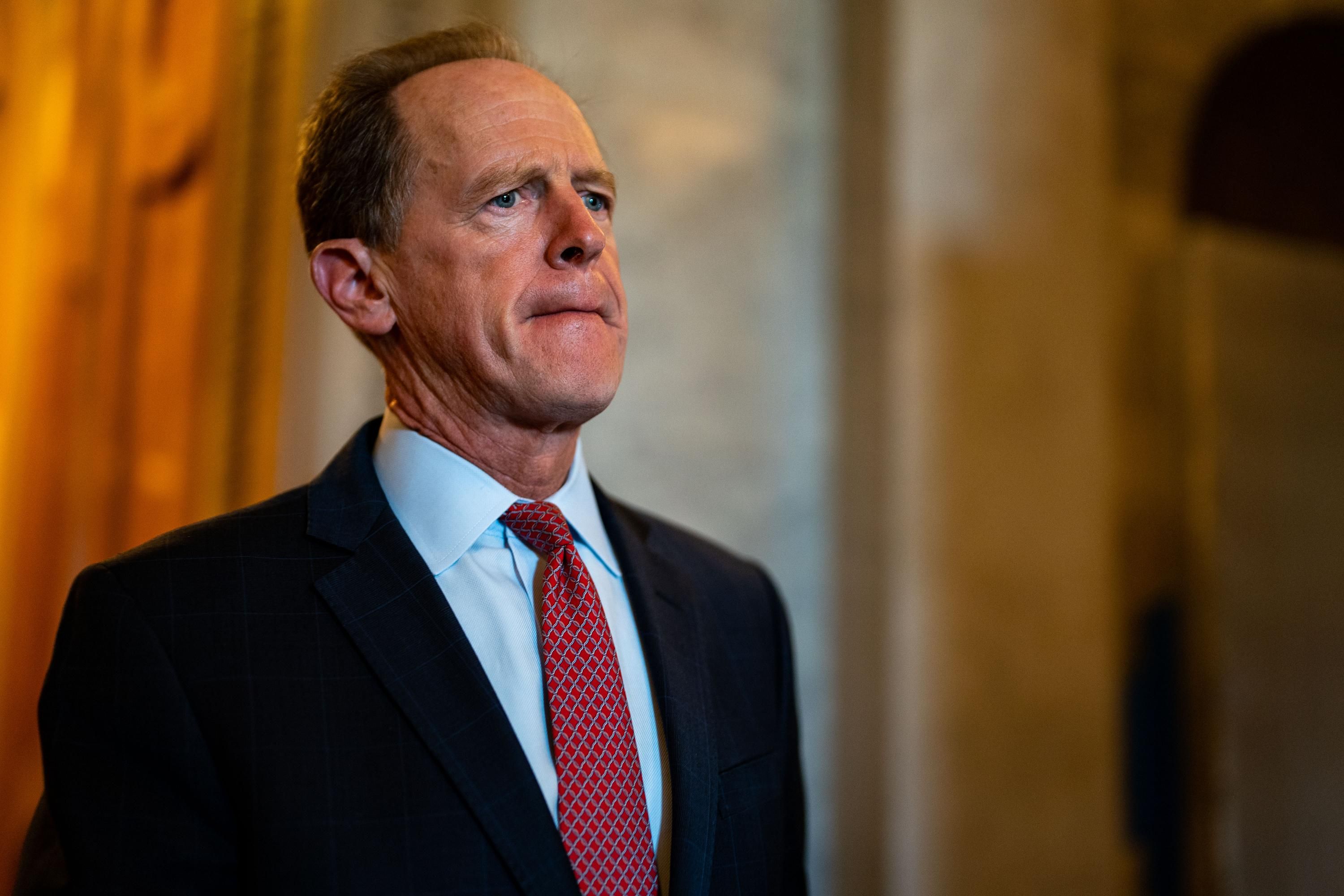 Sen. Pat Toomey walks in the Senate chamber