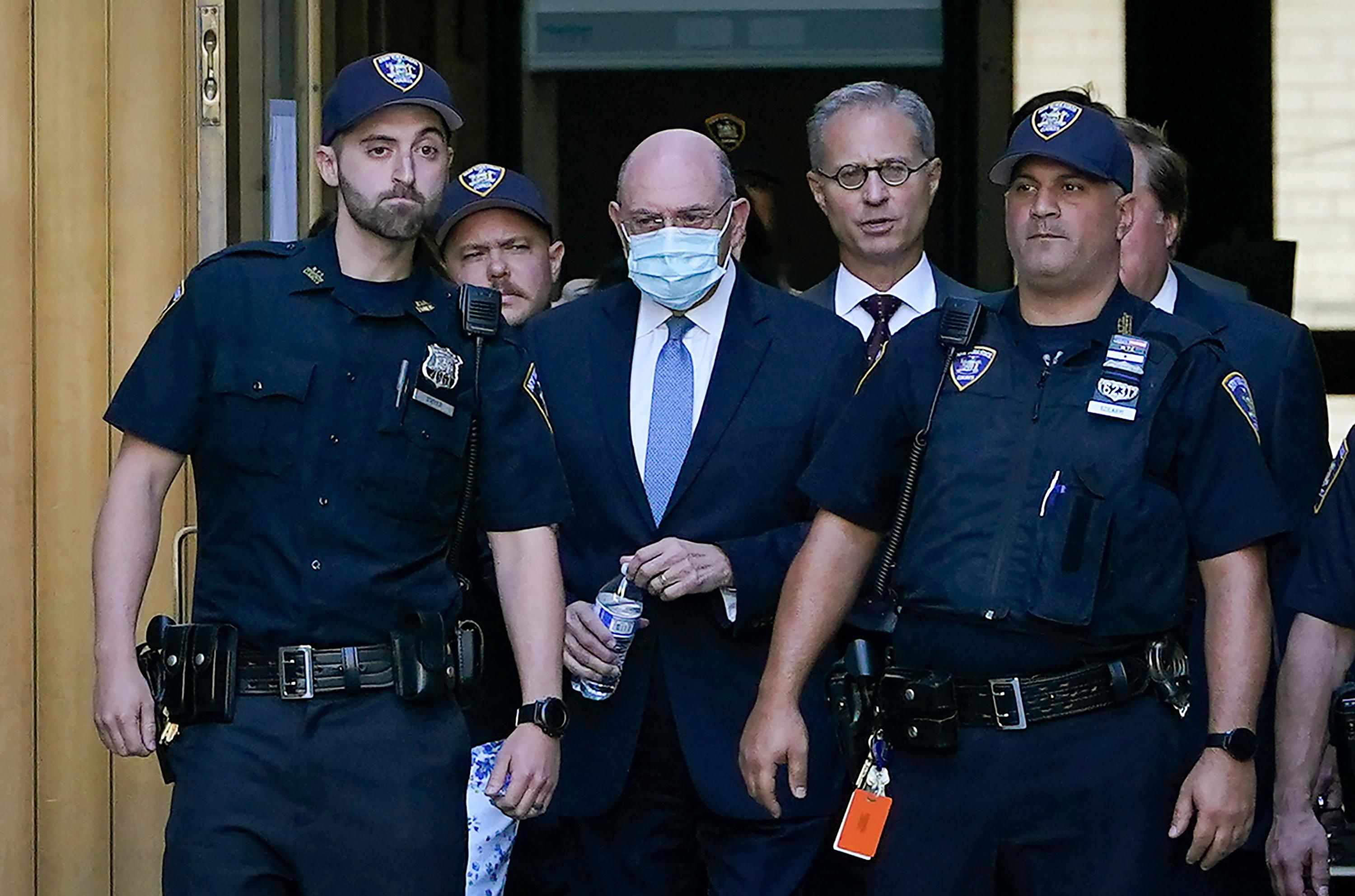 Allen Weisselberg leaves a courthouse