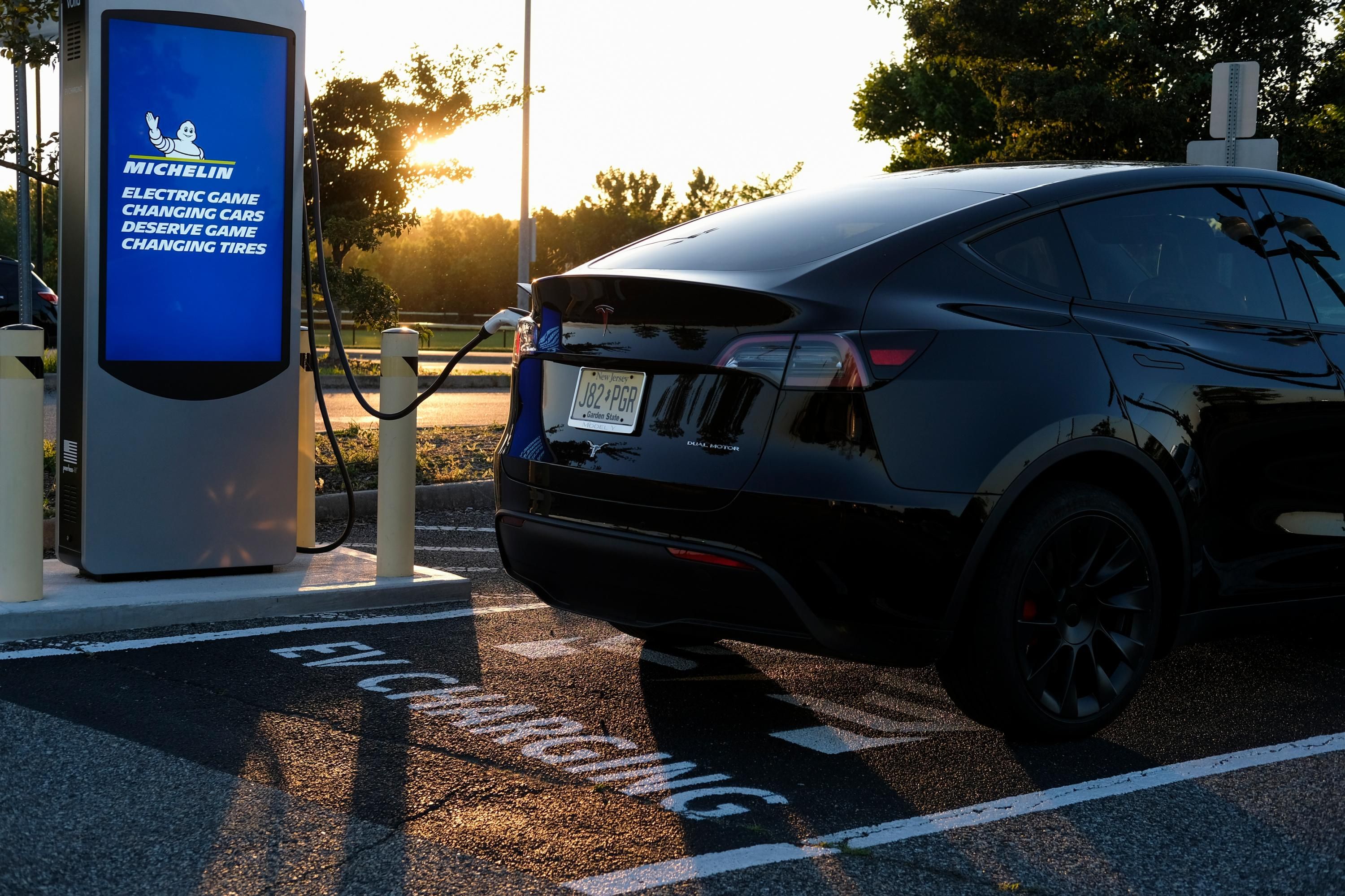 An electric vehicle is seen at a charging station in New Jersey