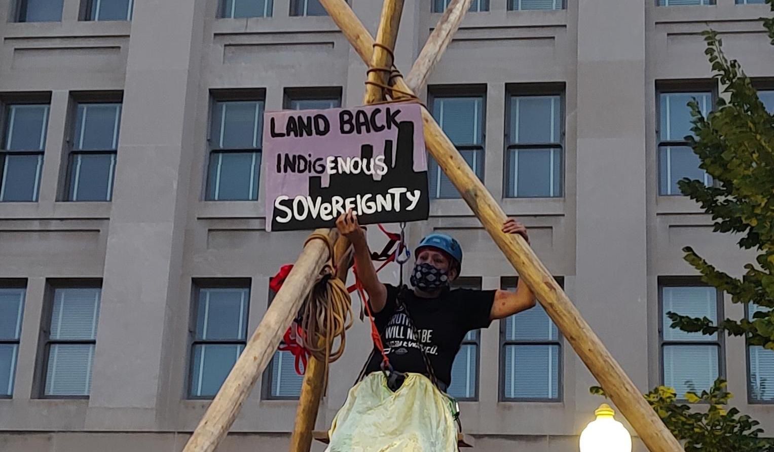 Indigenous demonstrators protest outside the Department of the Interior