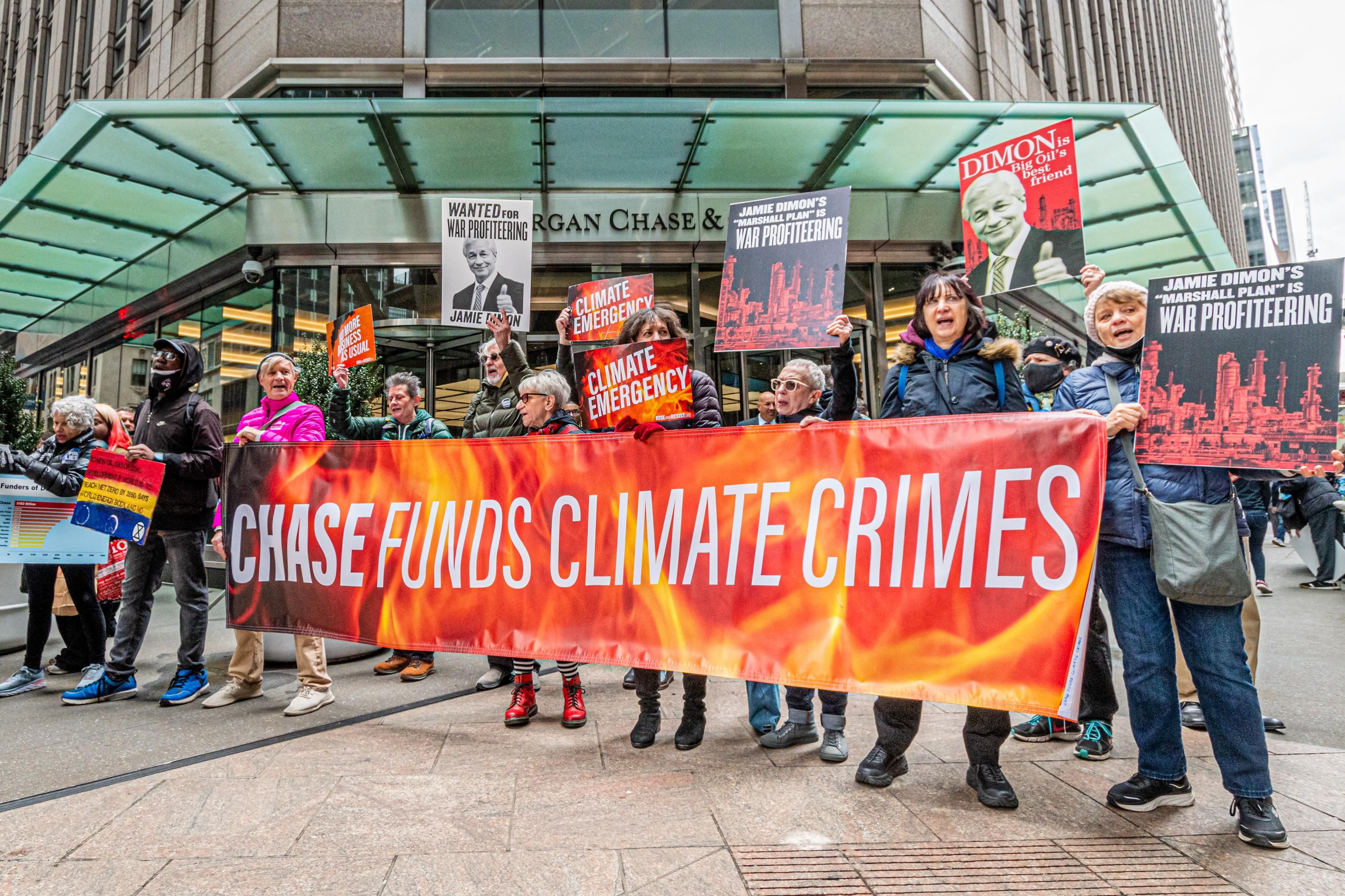 Protesters with banner reading, "Chase funds climate crimes"