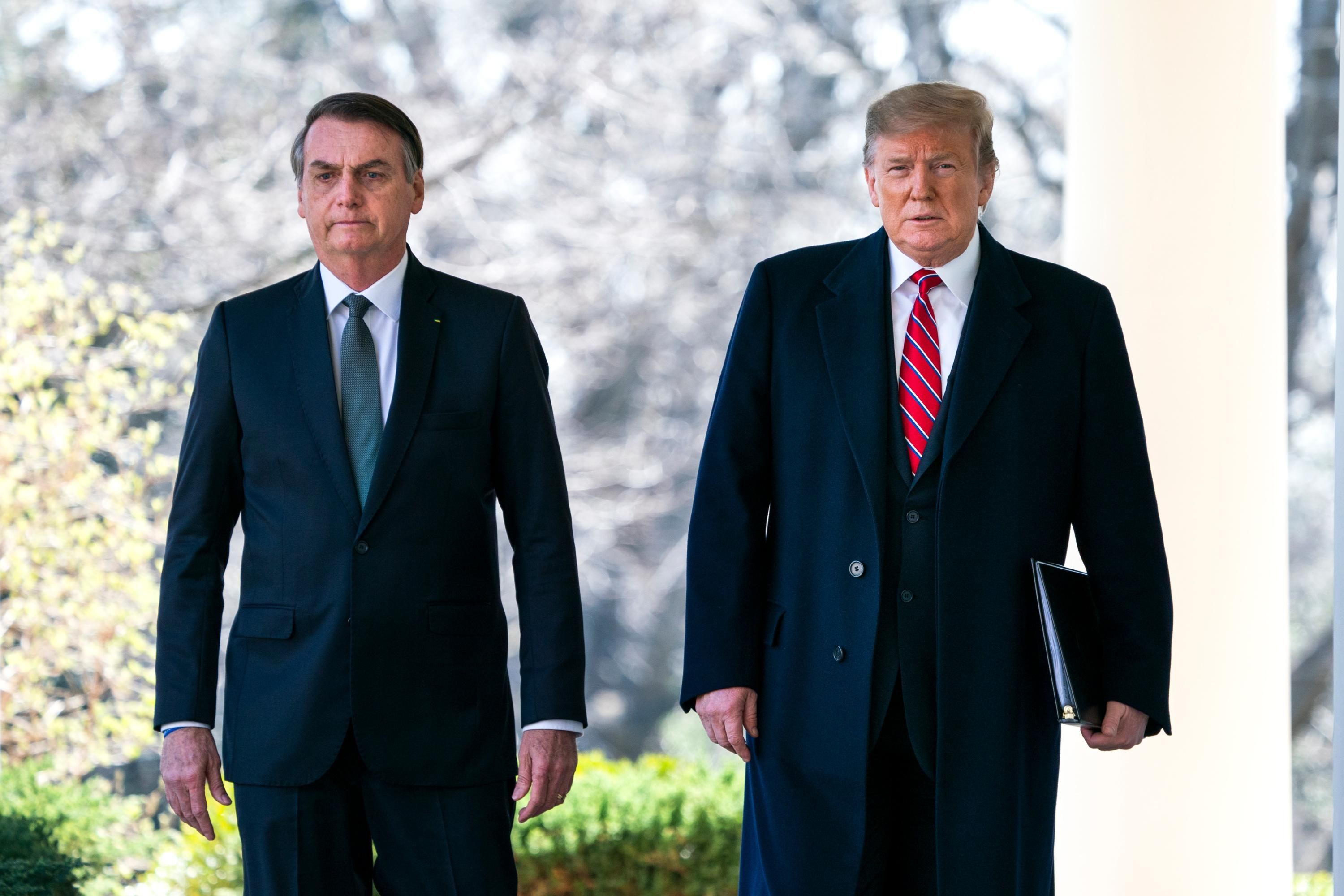 Then-U.S. President Donald Trump walks with Brazilian President Jair Bolsonaro