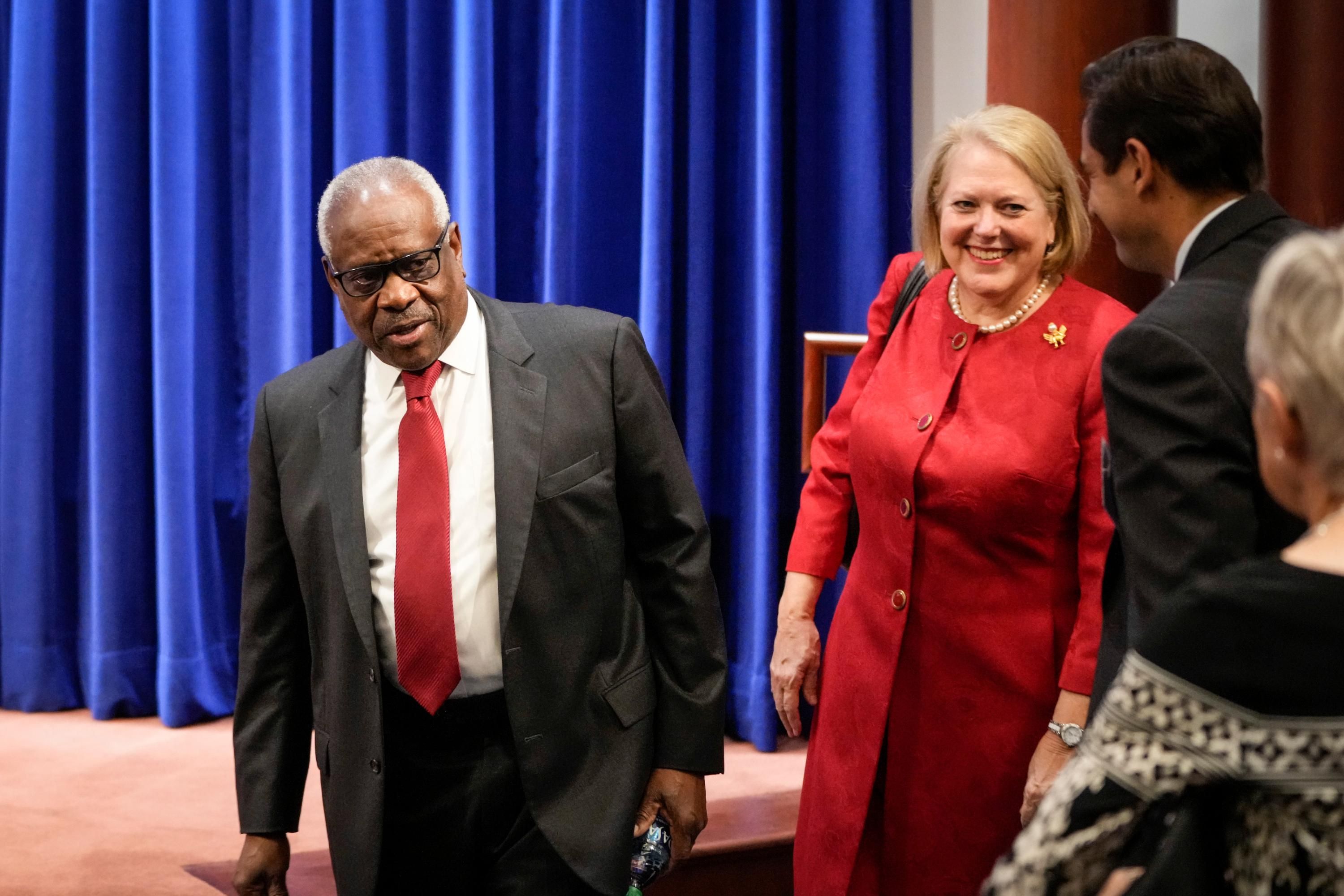 Supreme Court Justice Clarence Thomas arrives at an event with his wife Ginni Thomas