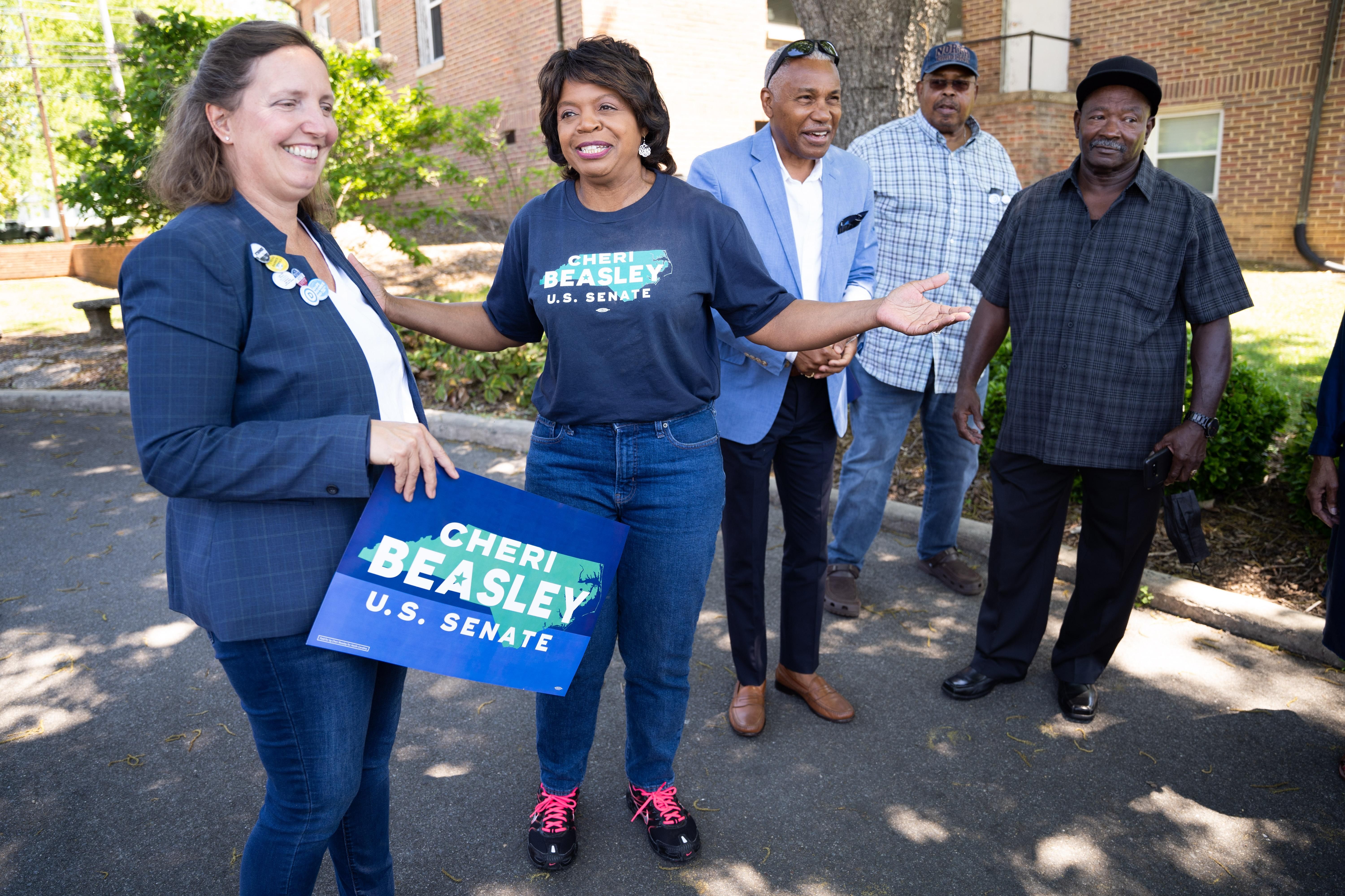 North Carolina Democratic Senate candidate Cheri Beasley (second from left) speaks with voters outside a polling location on May 17, 2022 in Troy, North Carolina.