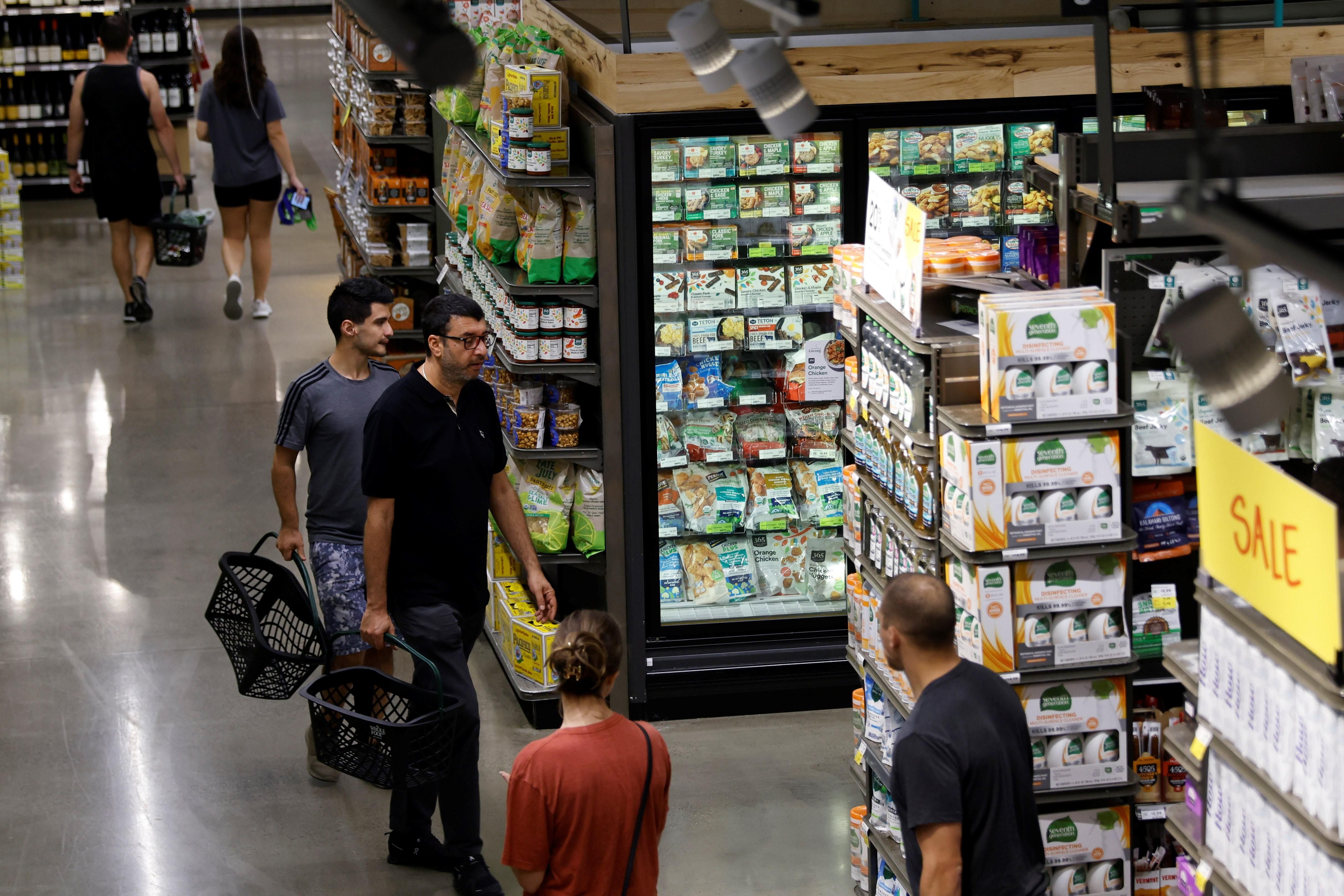 People shop at a local supermarket in Washington, D.C. on September 13, 2022. 