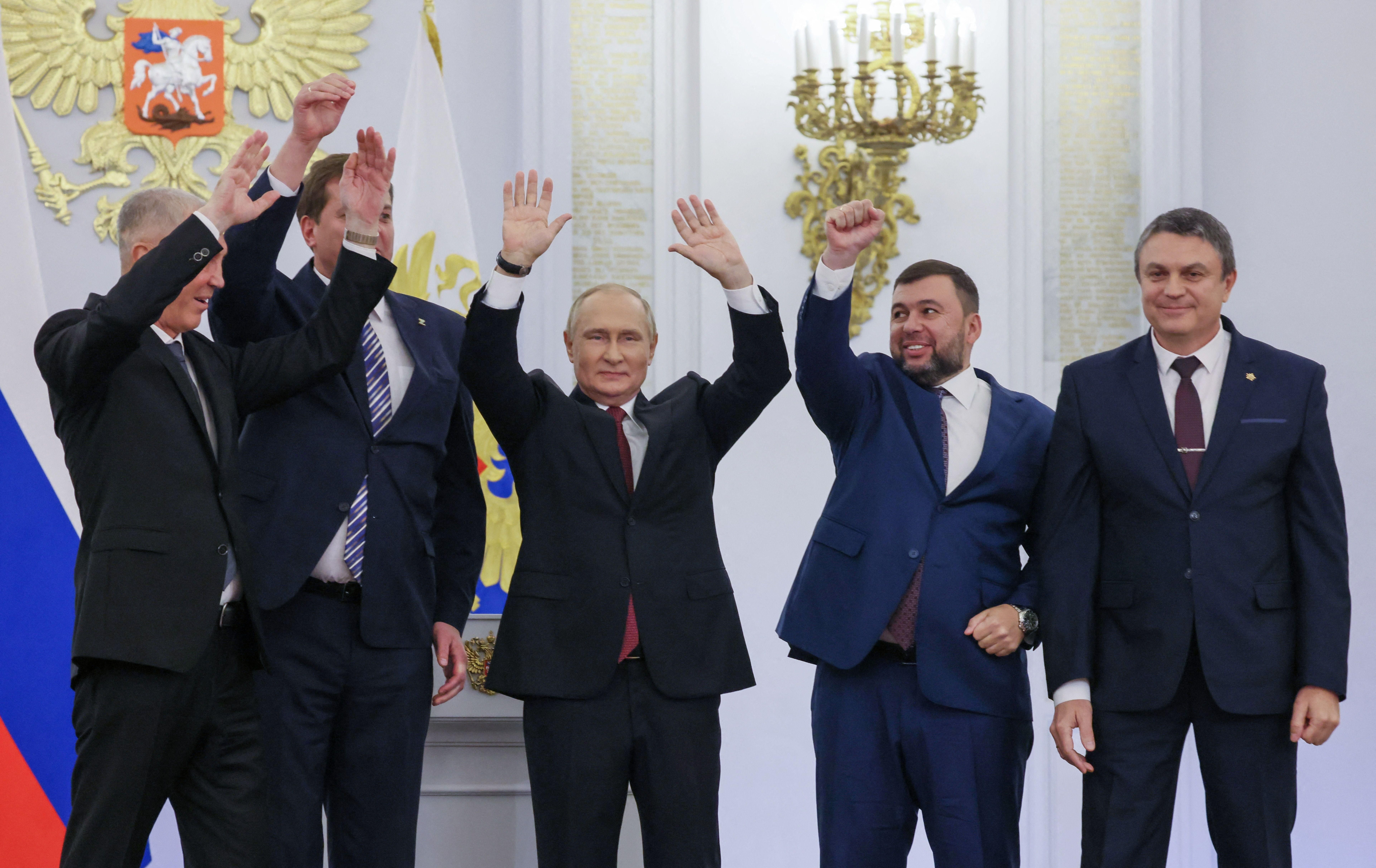 Russian President Vladimir Putin surrounded by other Kremlin officials and leaders of Donbas separatist groups