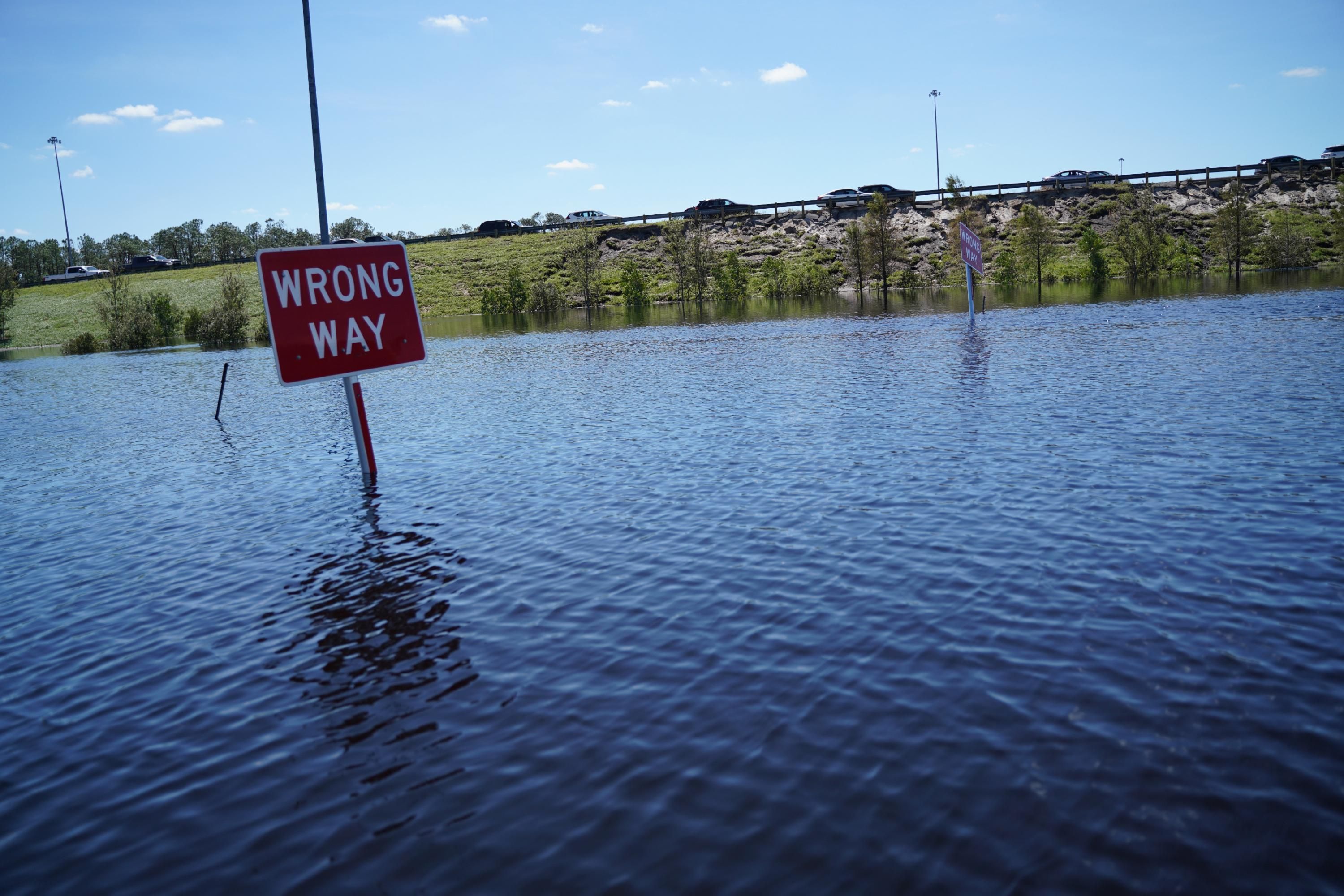 sign in flooded Florida reads 'wrong way'