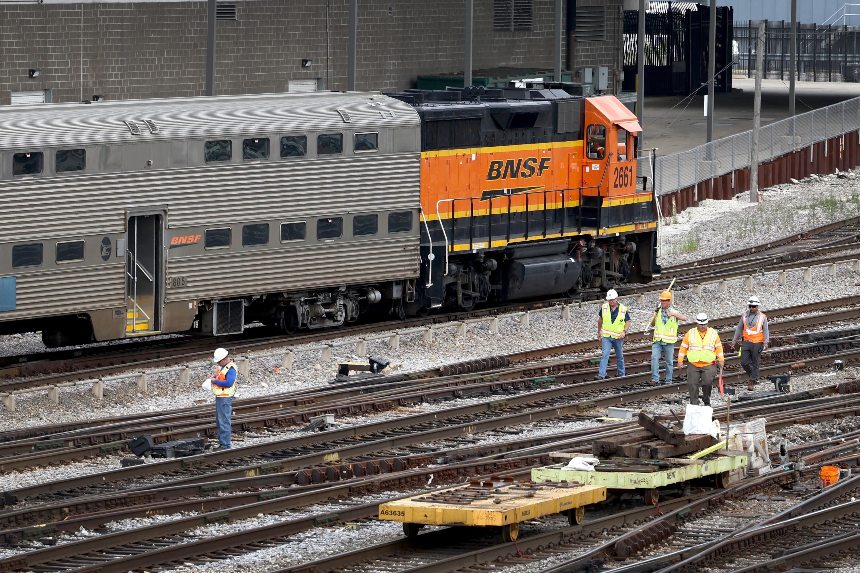 Rail workers service tracks in Chicago