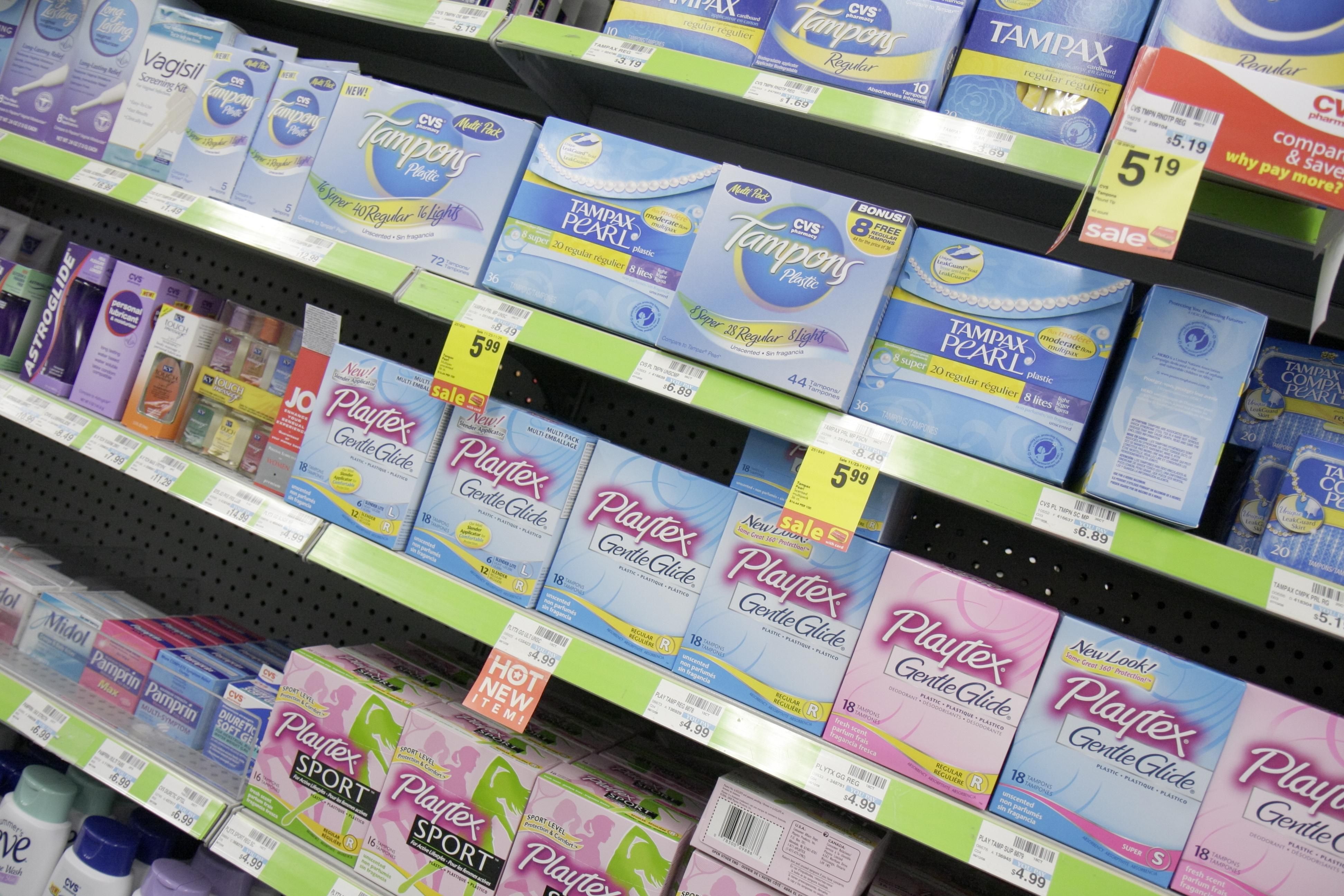 Tampons and other feminine hygiene products on a store shelf.