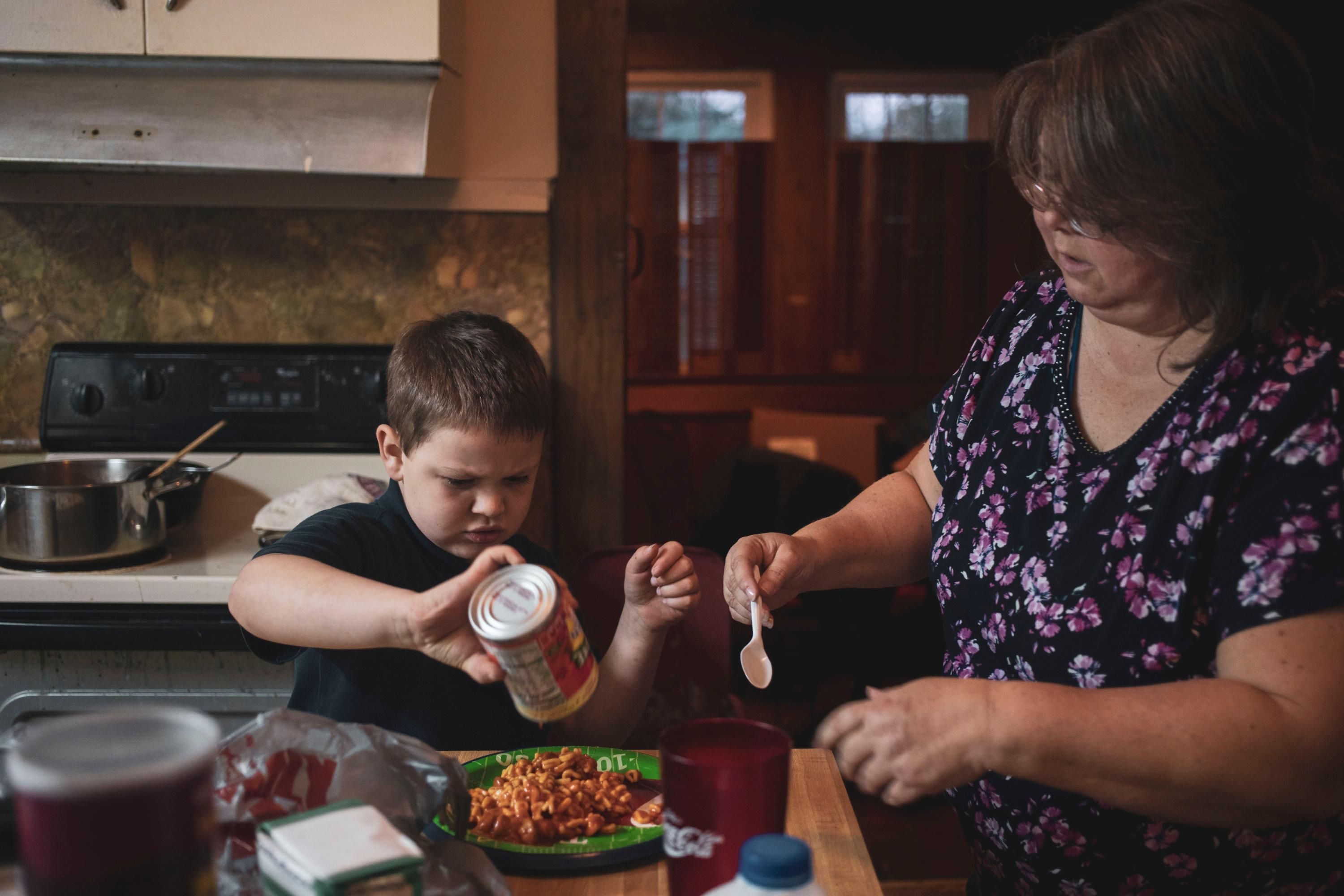 Boy makes dinner with his mother