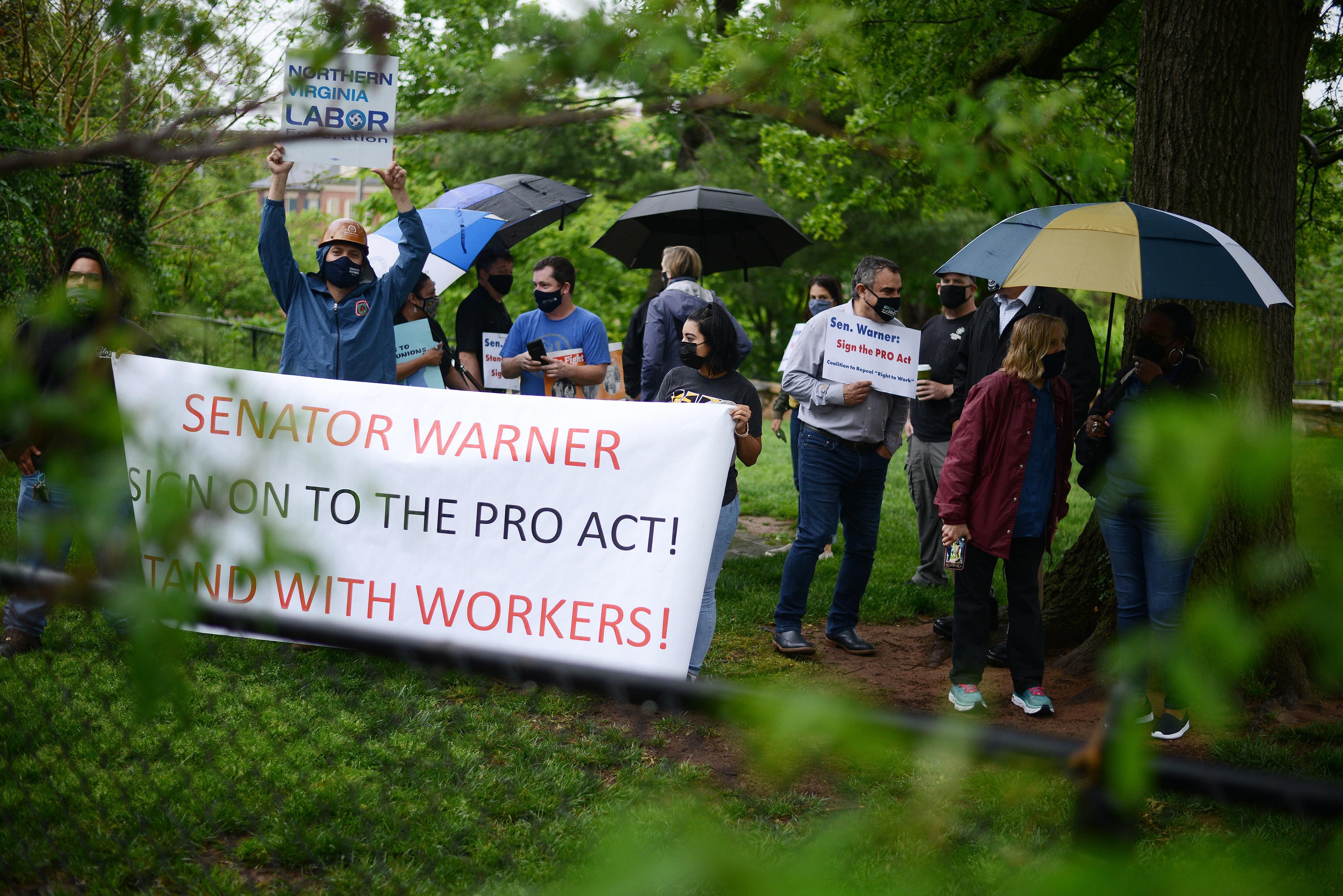 Union members demonstrate outside the home of Sen. Mark Warner (D-Va.), one of three holdouts in the Senate Democratic Caucus who has yet to
co-sponsor the PRO Act, in Alexandria, Virginia on May 5, 2021.
