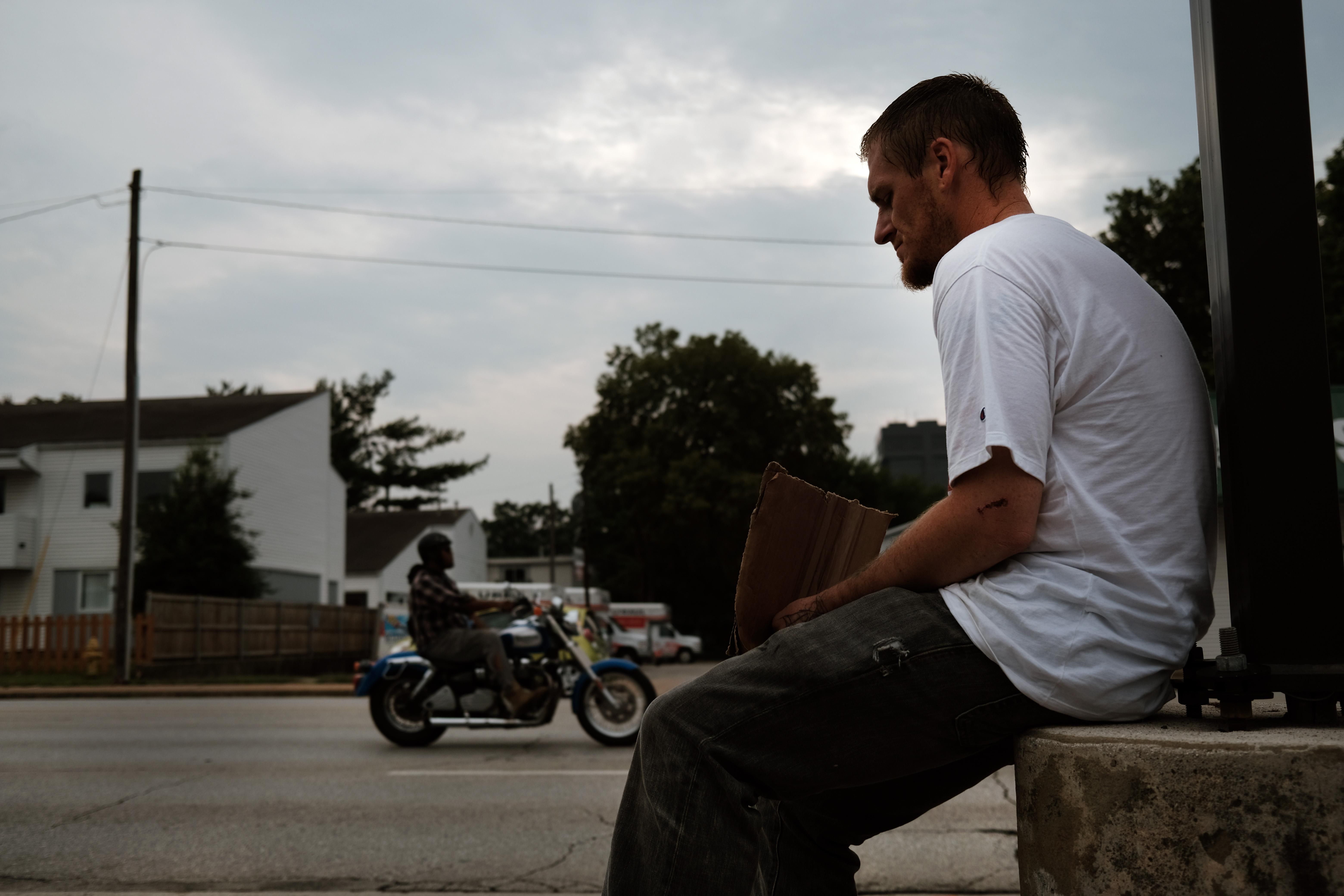 A homeless man named Caleb sits on a street corner on August 5, 2021 in Springfield, Missouri.