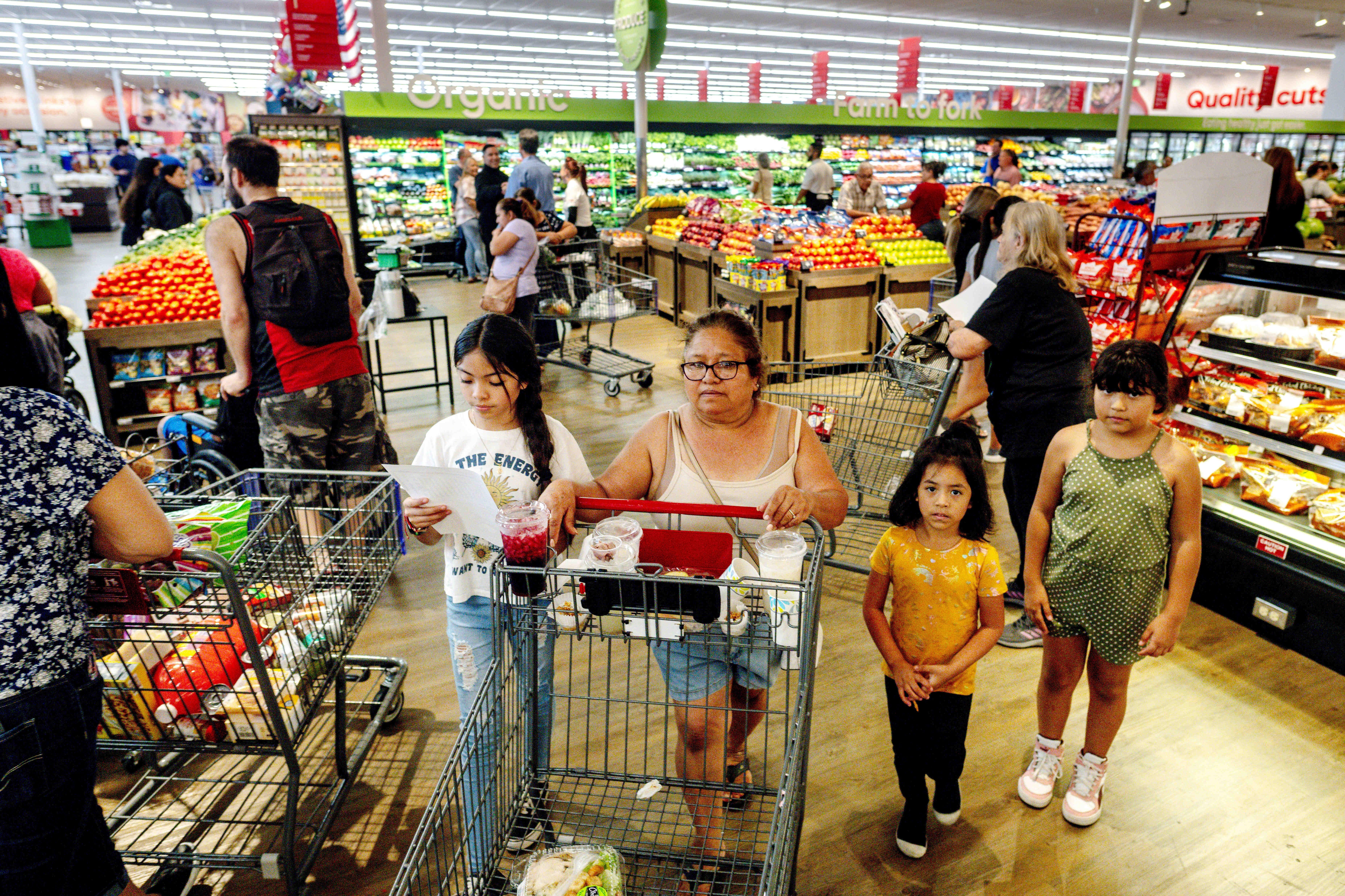 People shop for groceries in Riverside, California on September 28, 2022.