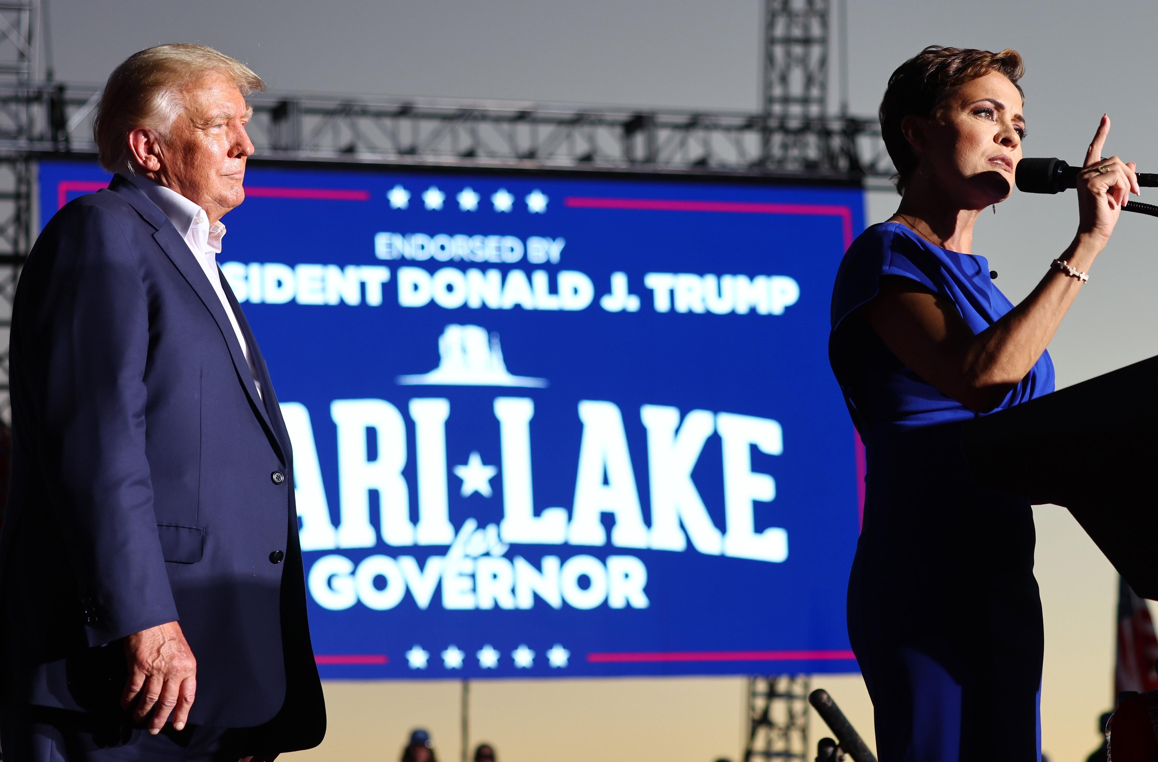 Donald Trump and Republican Kari Lake on stage at a rally for Lake in Arizona