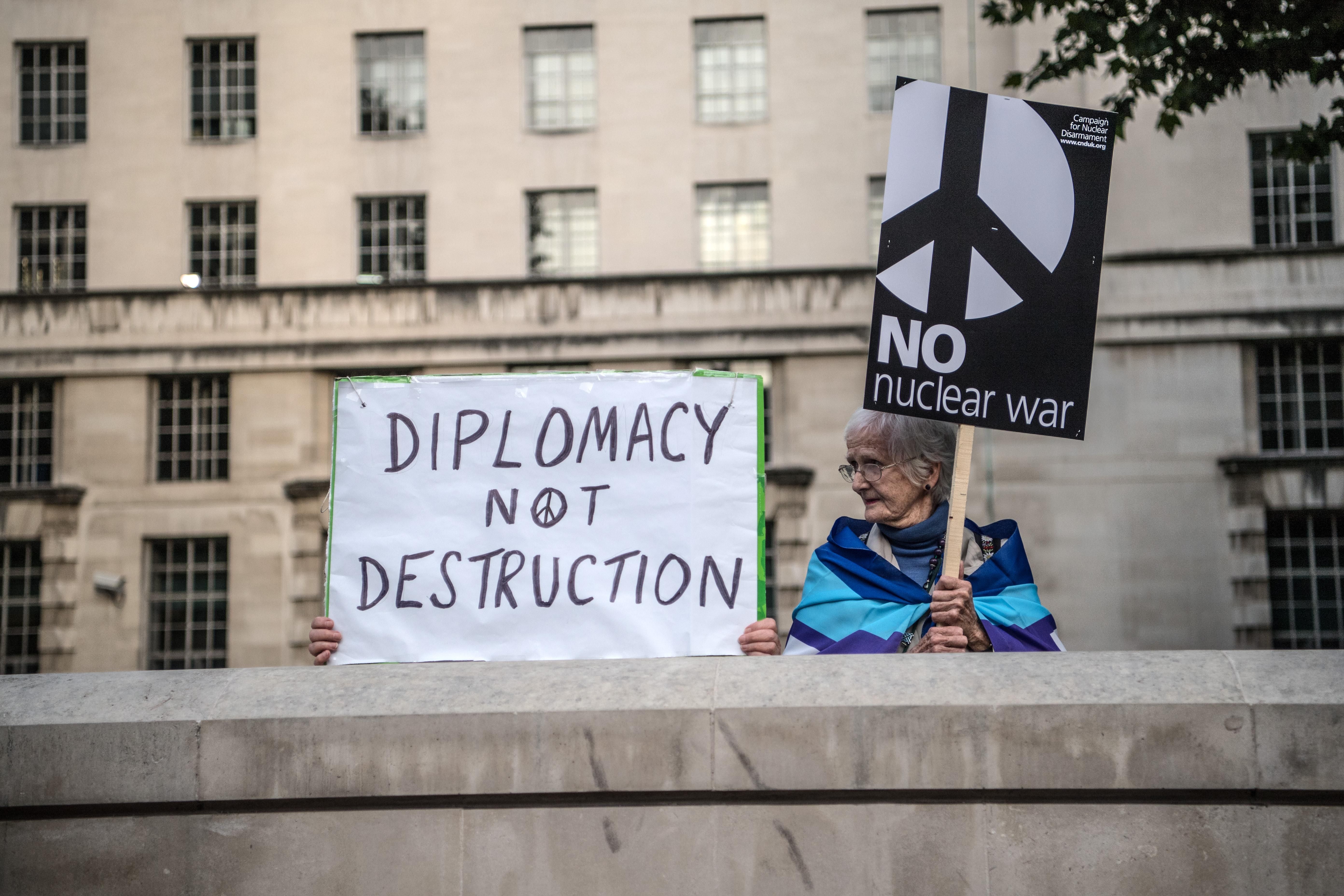 Signs read "Diplomacy Not Destruction" and "No Nuclear War"