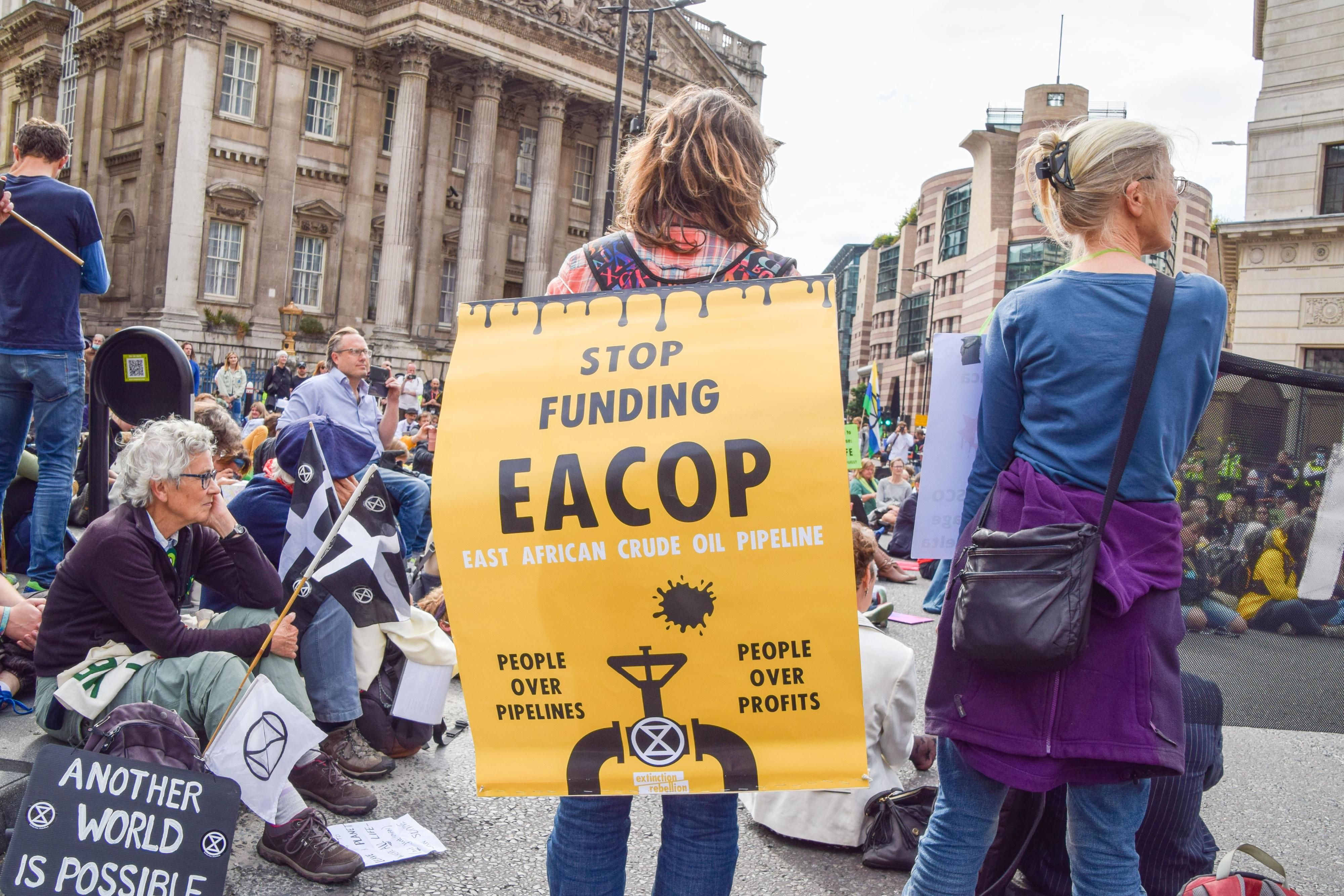 Sign reading, "Stop funding EACOP"