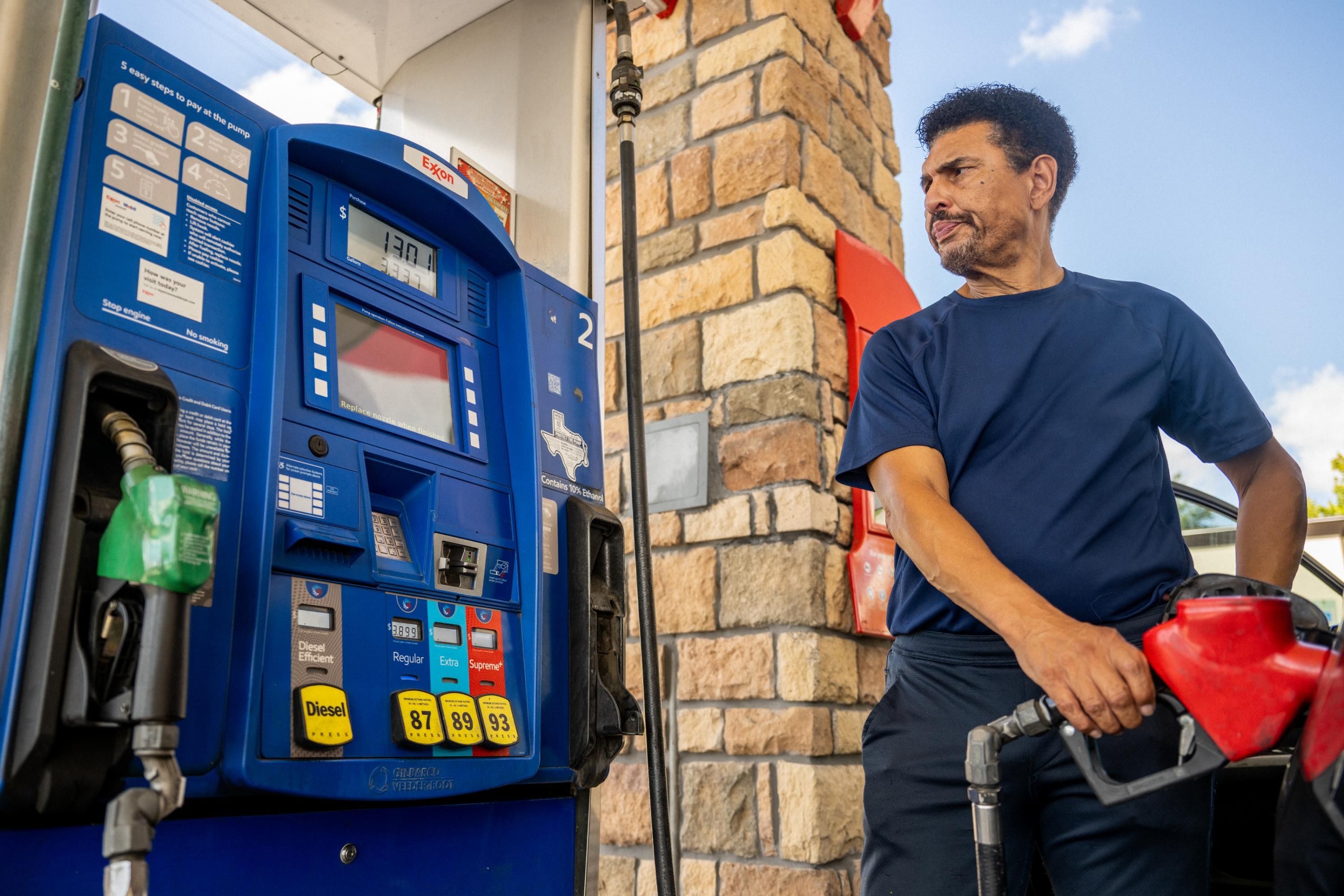 Man pumps gas at Exxon station
