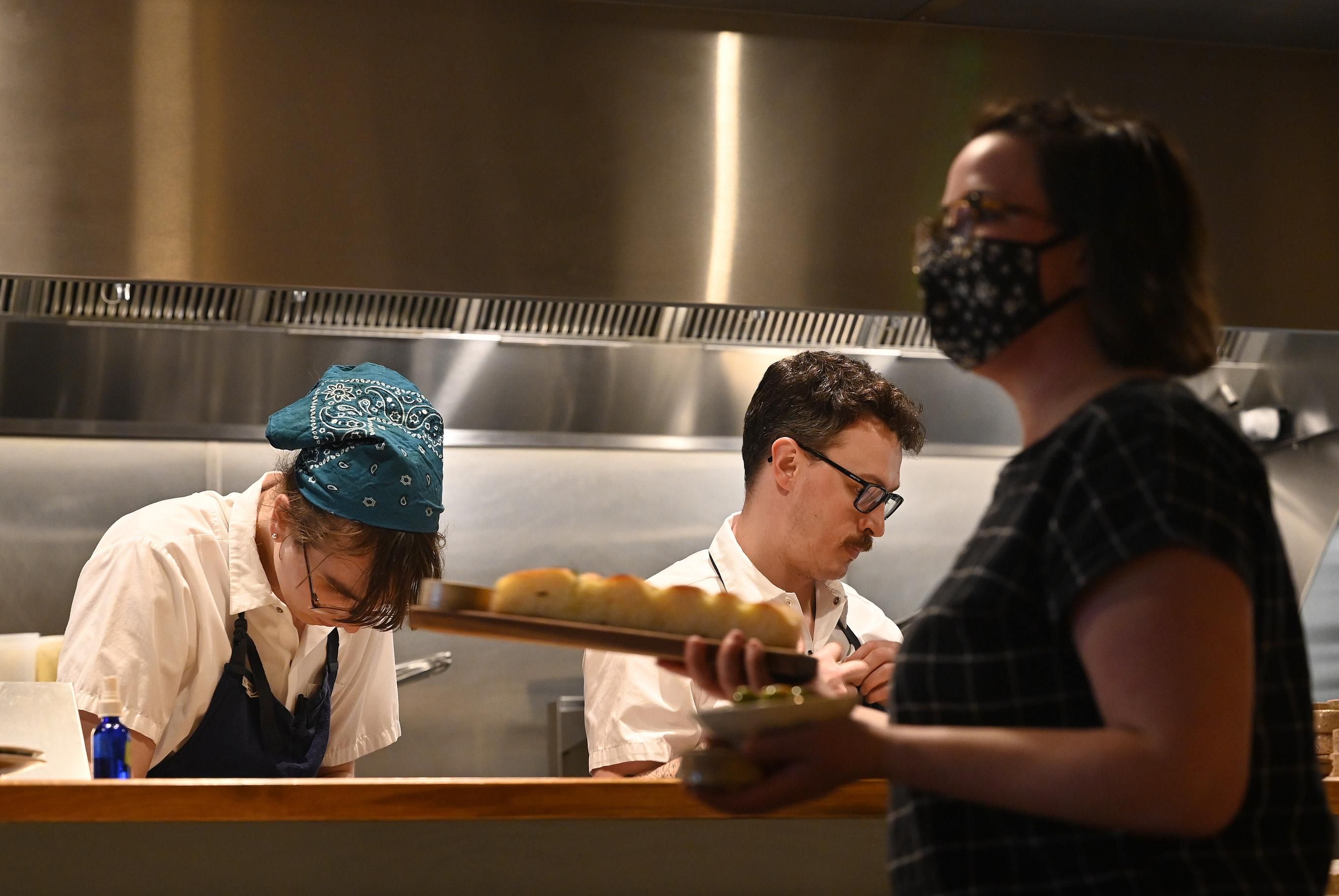 A server walks past the kitchen at Leeward in Portland, Maine on February 23, 2022.