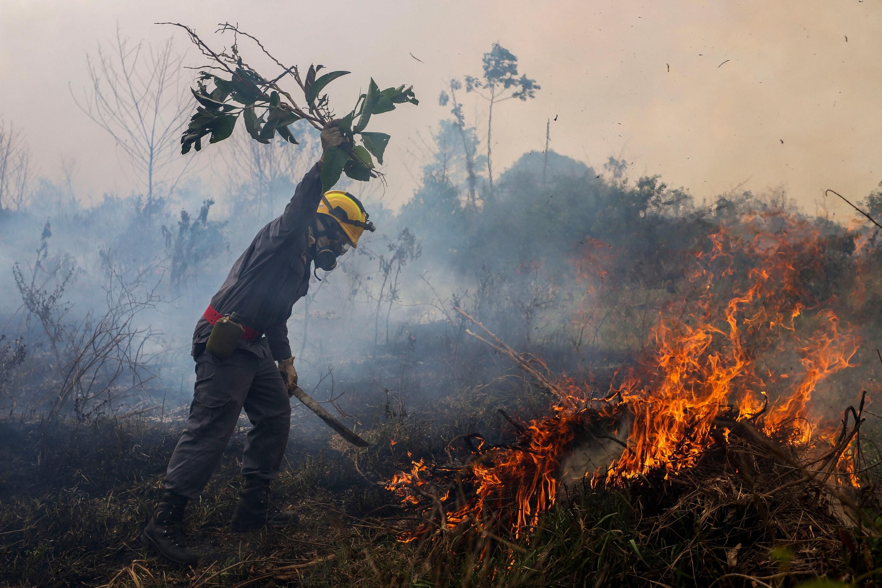 A firefighter combats a fire in the Brazilian Amazon