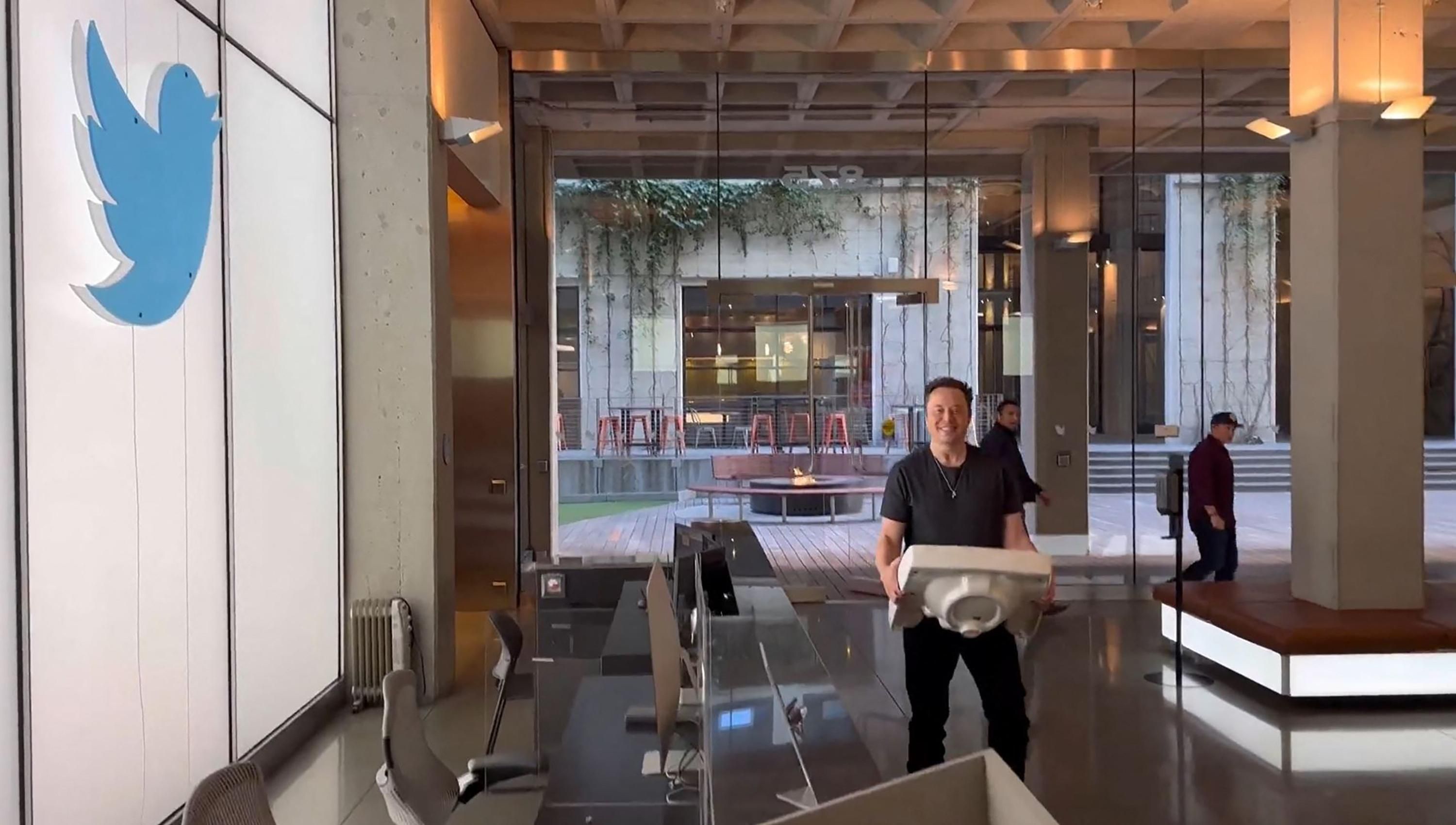 Elon Musk carries a sink into Twitter headquarters