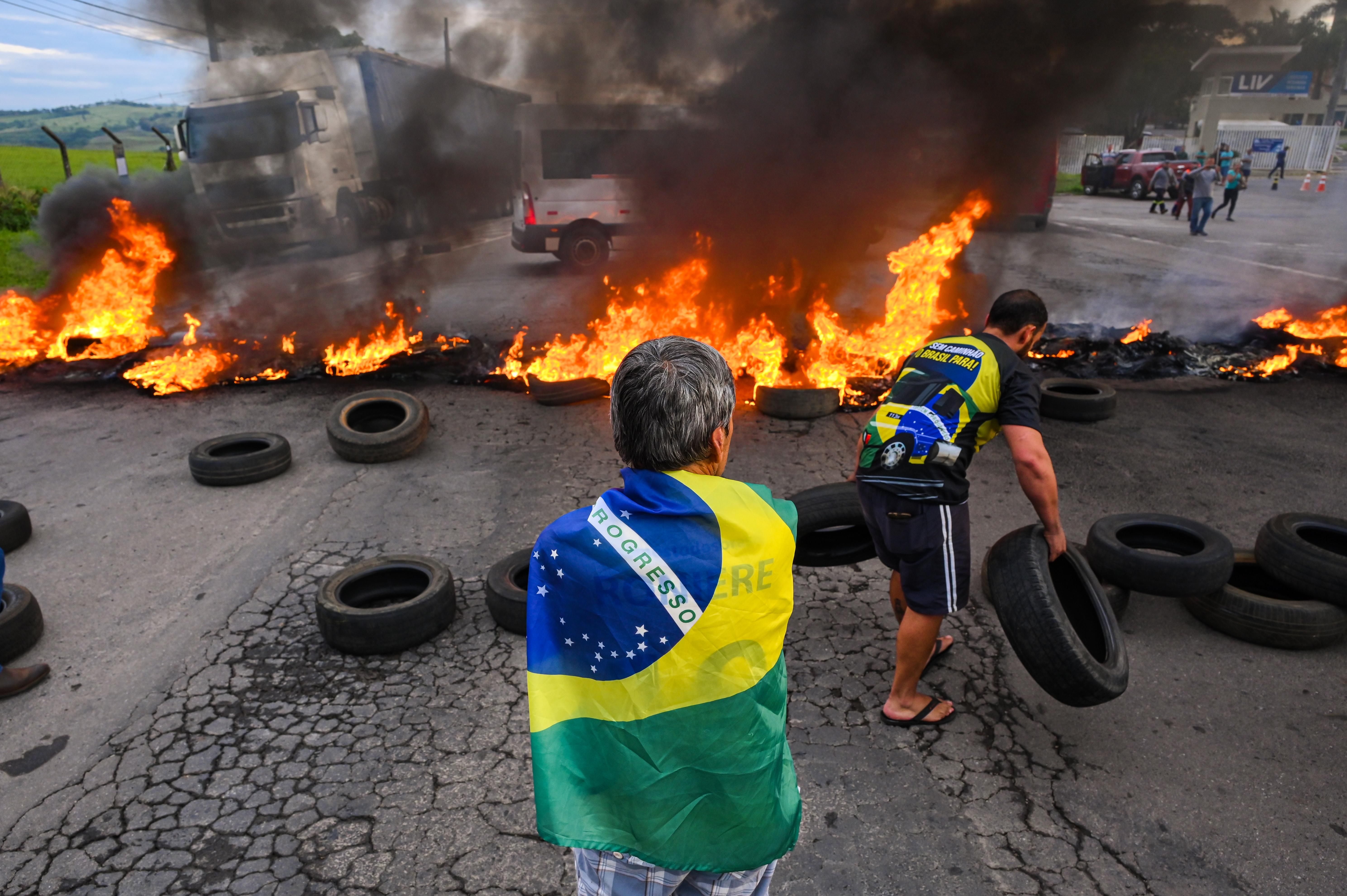 Bolsonaro supporters form a burning barricade to block a road on October 31, 2022 in Varginha, Brazil.