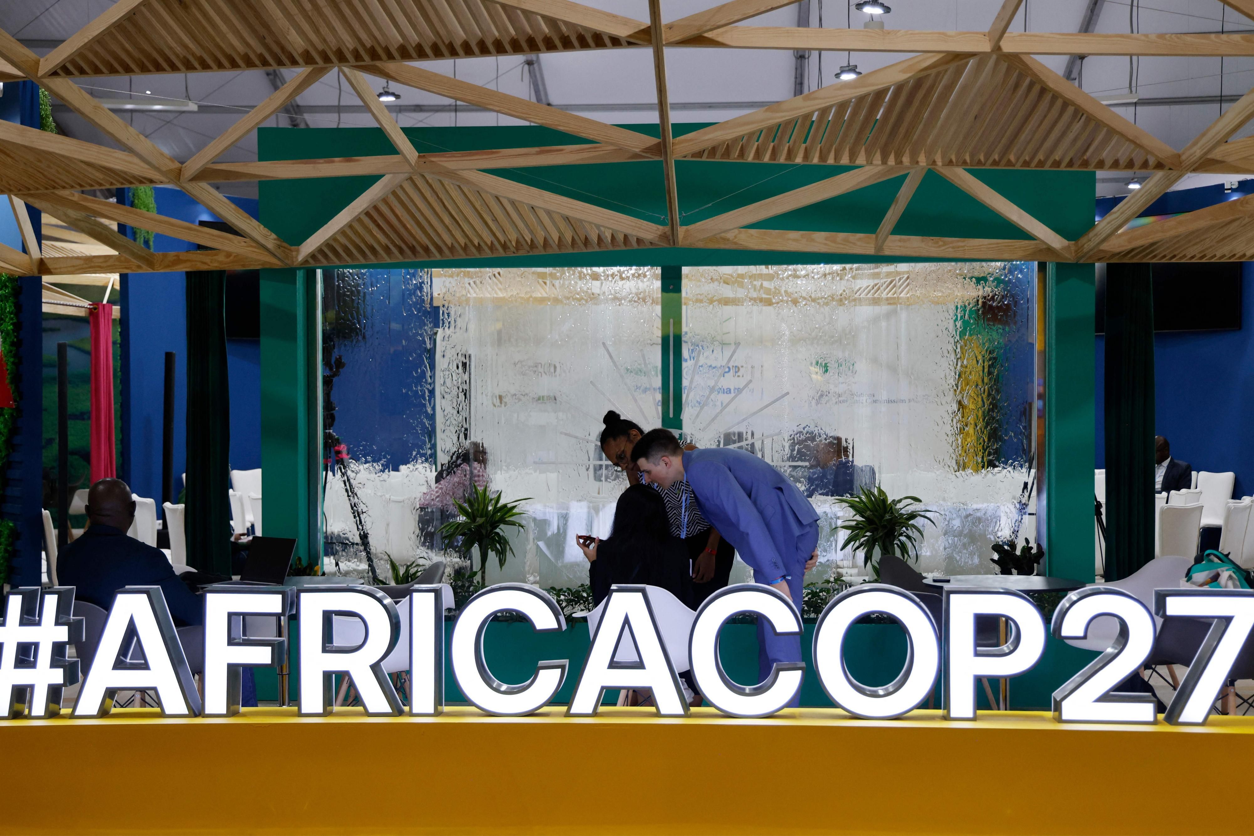 Sign reads "#AFRICACOP27" as UN climate summit kicks off in Egypt