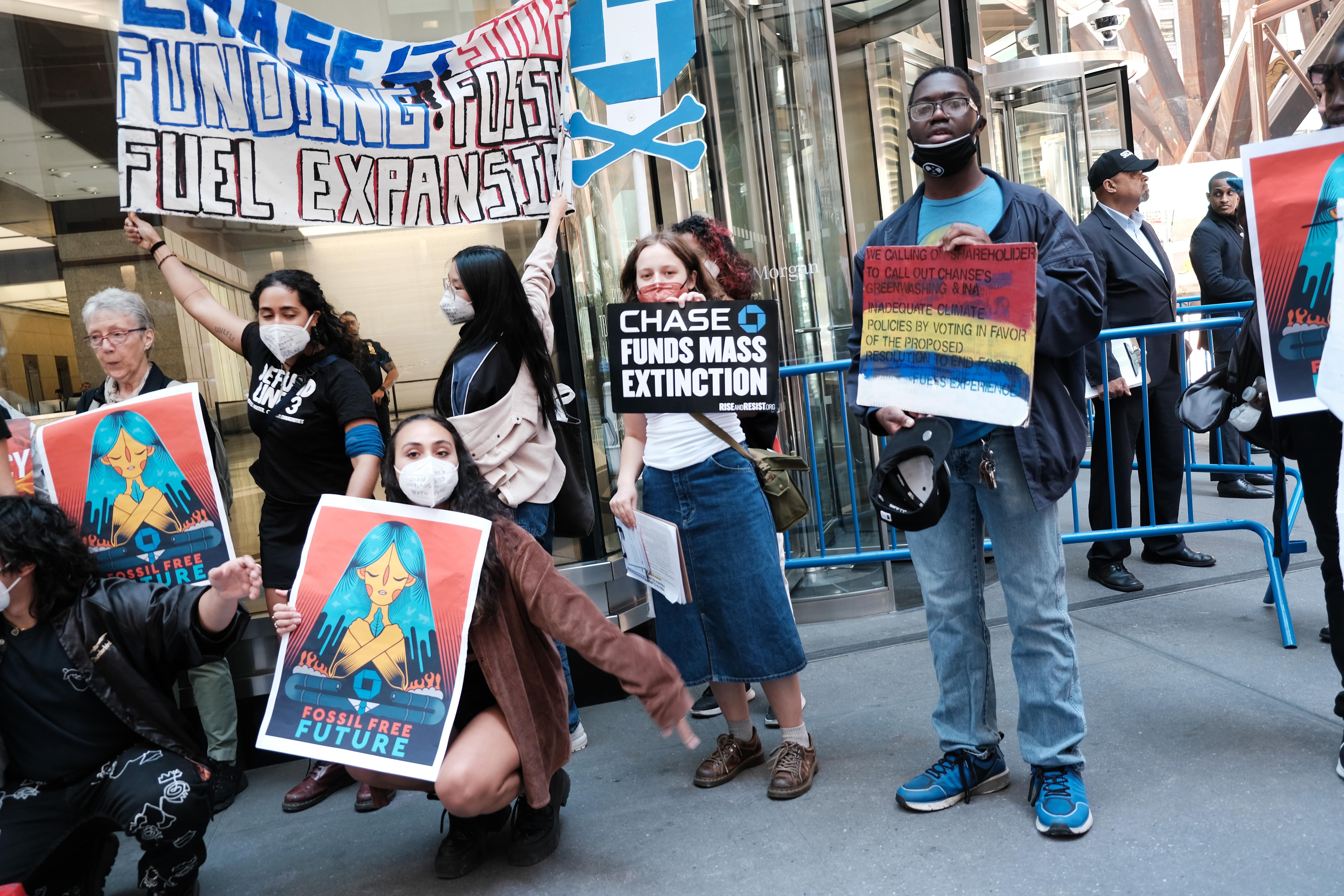 Climate activists demonstrate outside the headquarters of JPMorgan Chase during the bank's annual shareholder meeting on May 17, 2022 in New York City.