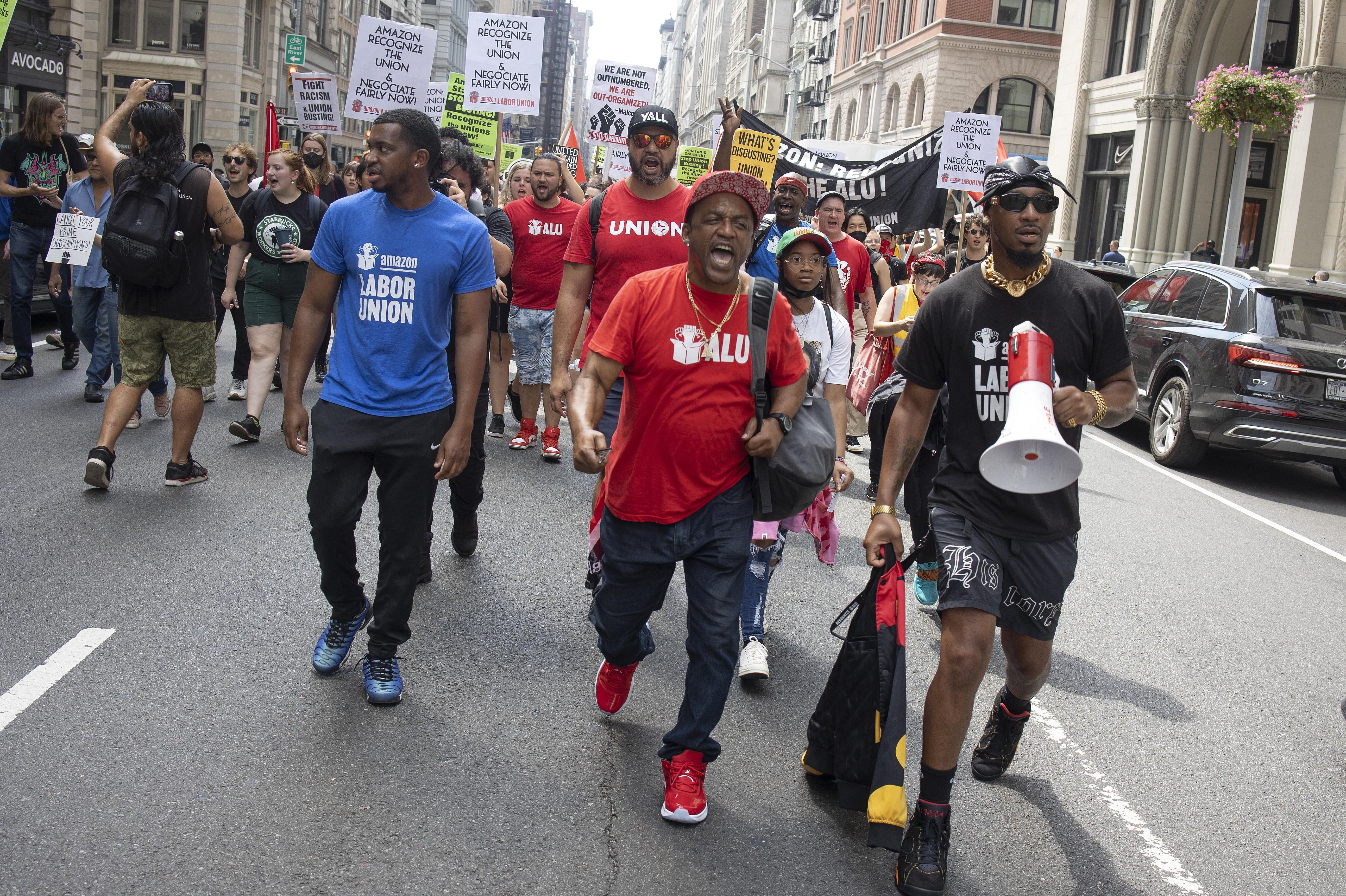 From left to right: Derrick Palmer, Gerald Bryson, and Chris Smalls of the Amazon Labor Union lead a Labor Day march on September 5, 2022 in New York City.