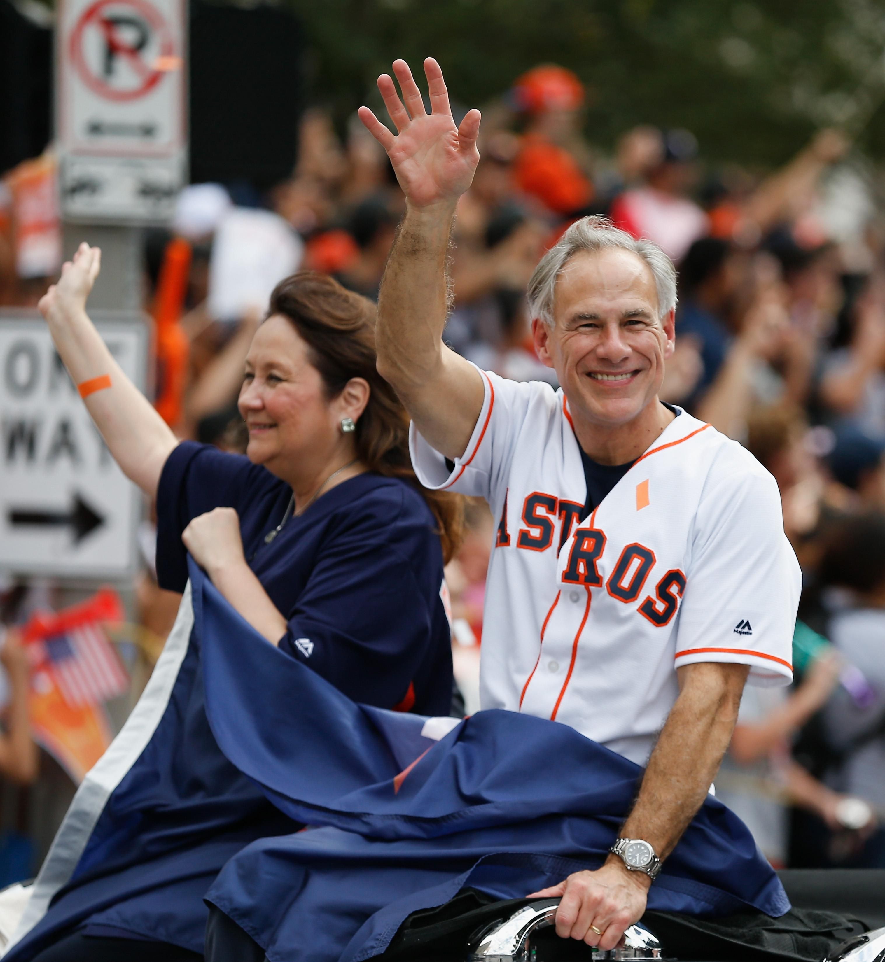 Texas Governor Greg Abbott and wife Cecilia Abbott wave