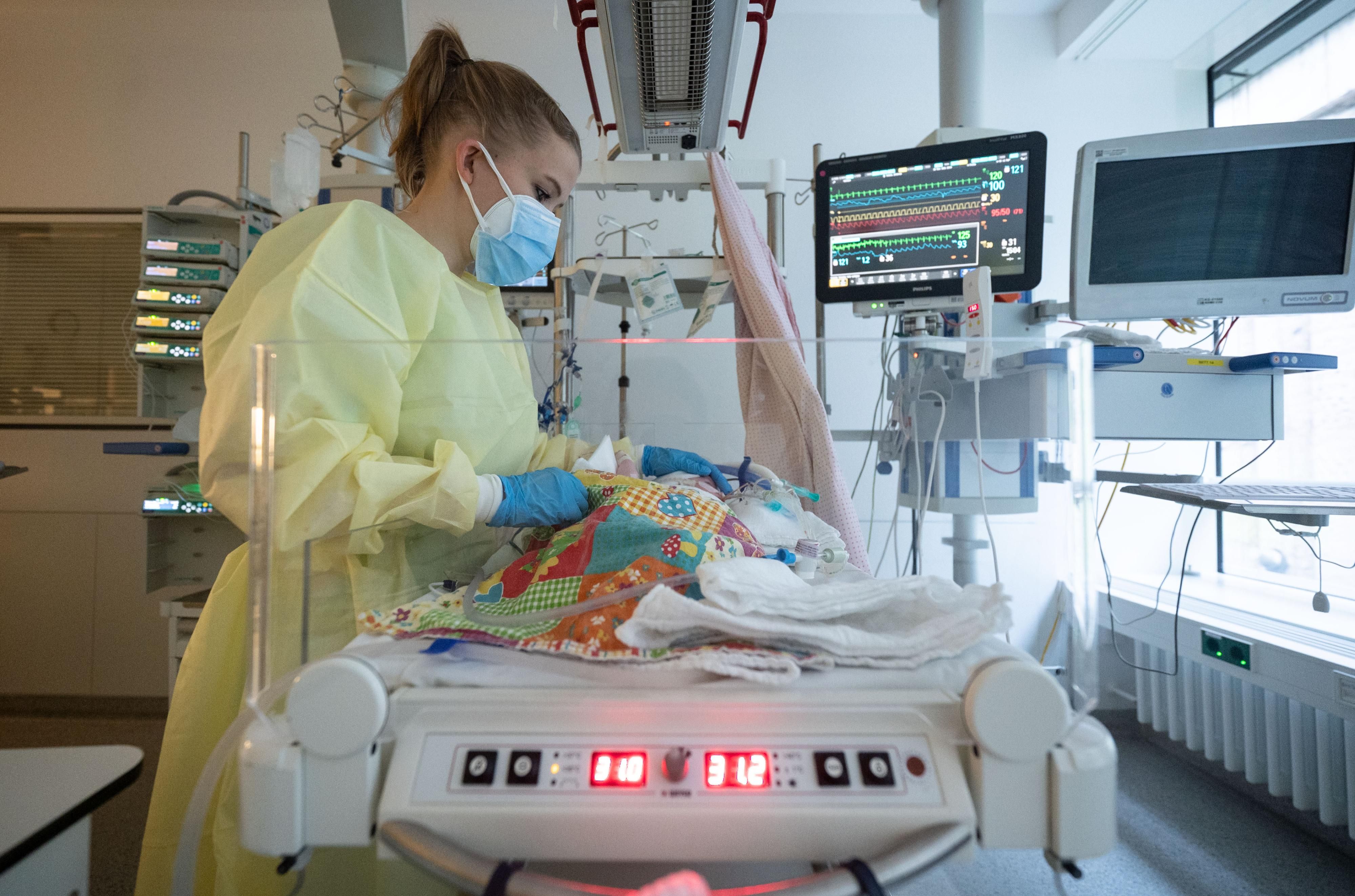 A nurse cares for a young patient with RSV