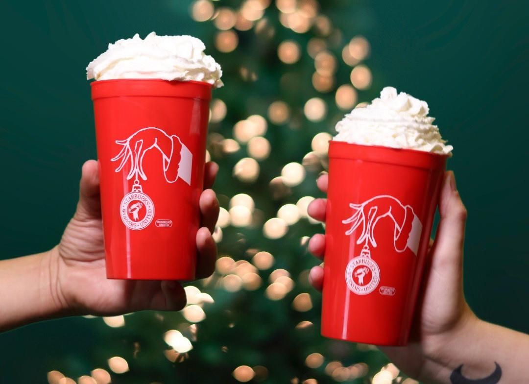 Starbucks workers hold union-branded cups