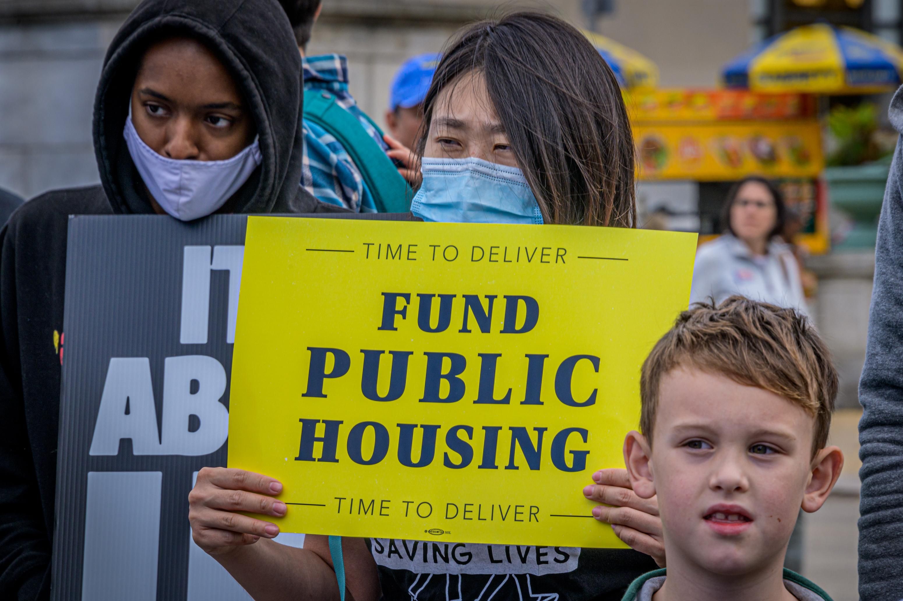 Fund Public Housing sign